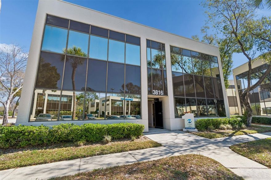 We are proud to present 3816 Gunn Highway, a versatile two-story office condominium located within the well-maintained One Carrollwood Place office complex in the heart of Tampa’s highly sought-after Carrollwood submarket. This professional environment offers an ideal setting for an owner-user or investor seeking a flexible commercial asset with strong surrounding demographics and excellent accessibility. Originally constructed in 1985, the property features approximately 3,000 SF across two floors, designed to accommodate a variety of professional office uses while offering enhanced operational flexibility. A key differentiator of 3816 Gunn Highway is the ±750 SF open storage and operational suite located immediately to the left upon entry. This space features removed drop ceilings with exposed height, concrete flooring, integrated lighting, and direct restroom access—making it ideal for product storage, equipment staging, IT infrastructure, archives, light distribution, or service-based operations requiring back-of-house functionality within a professional office setting. The remainder of the building includes a balanced mix of private executive offices, conference space, and open work areas across both levels. Expansive floor-to-ceiling window lines provide abundant natural light throughout, creating a bright and professional working environment. The two-story configuration enhances privacy and allows for departmental separation or potential multi-suite configuration depending on ownership strategy. Strategically positioned along Gunn Highway—one of Carrollwood’s primary commercial corridors—the property benefits from strong visibility and immediate access to Dale Mabry Highway, the Veterans Expressway, and the greater Tampa metro. Surrounding retail, dining, and service amenities further enhance convenience for employees and clients alike. 3816 Gunn Highway presents a rare opportunity to acquire a well-located office condominium that seamlessly blends professional office presence with integrated operational capacity. Whether occupied by an end-user, leased as an investment, or configured as a hybrid owner/investor space, this property combines flexibility, functionality, and location within one of Tampa’s most stable suburban commercial hubs.