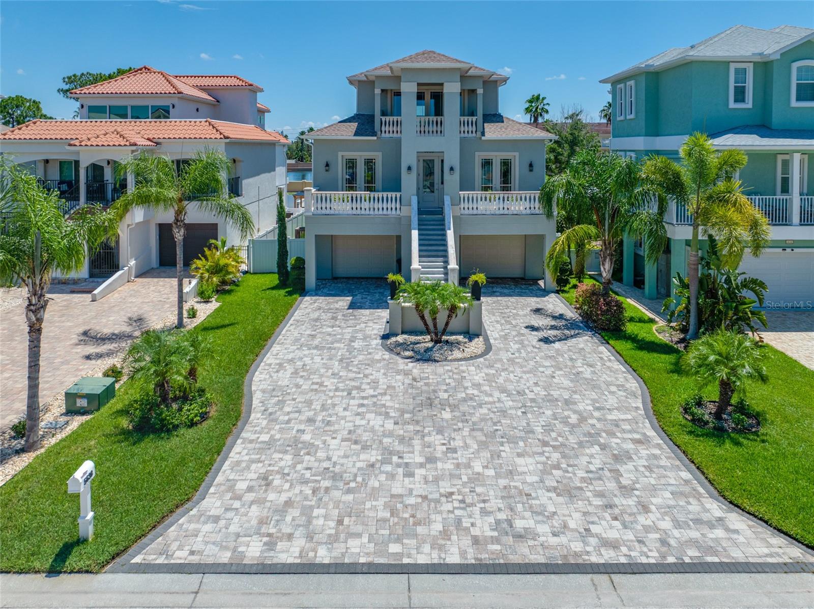 Welcome to this stunning home located in the gated subdivision of Egrets Place, in the waterfront & boating community of Gulf Landings. From the moment you arrive, you’ll appreciate this home’s unique character highlighted by an extended paver driveway and lush tropical landscaping. This spacious floor plan offers 4 Bedrooms, 4.5 Baths, & an inviting Great Room where the open Kitchen overlooks the Living Room—perfect for entertaining. The first level consists of 1,700+ SqFt garage area that can accommodate 3 cars tandem-style, complete with epoxy flooring & mini-split AC system. Inside, you’ll find luxury vinyl plank flooring throughout the main living areas and a 3-story elevator for convenience. The gourmet kitchen boasts quartz countertops & backsplash, wood cabinetry, and stainless steel appliances including a double oven. The entire third level is dedicated to an oversized primary suite with a private balcony, a custom-designed walk-in closet, & spa-like bathroom featuring quartz counters, wood cabinets, freestanding soaker tub, & large frameless glass shower. Additional features include 8-foot interior doors and multiple outdoor living spaces, including a 520 SqFt covered lanai and three separate balconies accented with precast concrete balusters. Enjoy Florida living at its best with a screen-enclosed pool with paver decking and an expansive, fully fenced backyard offering privacy and space for outdoor enjoyment. Built for peace of mind, this home is equipped with hurricane impact-rated windows and doors. As a resident of Egrets Place, you’ll enjoy access to Gulf Landings’ premier amenities, including two community boat ramps, clubhouse, pool, tennis courts, and pickleball courts. From Gulf Landings, it’s only a short boat ride to the open Gulf, and you’ll also have access to the private beach at Gulf Harbors Beach Club. This property truly has it all—luxury, functionality, and an unmatched coastal lifestyle. Don’t miss this opportunity to make this home your own!