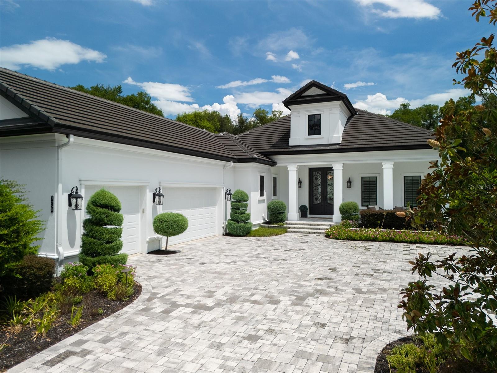 Located in Golden Ocala, right next door to the World Equestrian Center, this spacious home combines elegance and functionality with 3 bedrooms and 3.5 bathrooms. The open floor plan is designed for modern living, featuring high ceilings, tile and wood flooring throughout, and carpeted bedrooms for added comfort. The kitchen is equipped with top-quality appliances, a wine refrigerator, and a bar area, making it ideal for both daily use and entertaining. Generously sized walk-in closets provide ample storage, while a 3-car garage offers convenience. Sliding glass doors lead seamlessly to the outdoor living space, complete with a kitchen, lounge area, and pool. Surrounded by beautifully landscaped grounds, this property provides an exceptional opportunity to enjoy the Golden Ocala lifestyle just steps from WEC!
