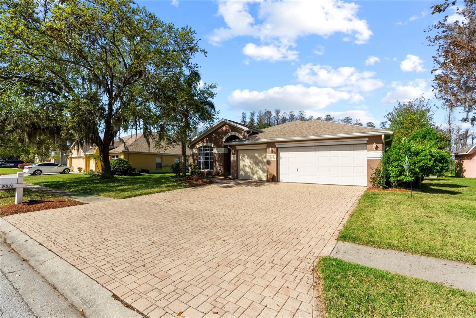 Motivated Seller!!! 20k price drop!!Welcome HOME to this stunning 4 bed, 3 bath pool home with a bonus room and 3 car garage in the sought-after Wyndham Lakes community! From the moment you step through the impressive double-door entry into the 12’ vaulted ceilings, you’ll feel the warmth and love this home has to offer. But the real showstopper? The UNBEATABLE double water views—the conservation lot overlooks a peaceful pond with a partial view of Lake Osceola, providing a serene and private backyard oasis. This home has a thoughtfully designed split floor plan perfect for entertaining, with a formal dining room and an open-concept kitchen + family room. The kitchen has granite countertops, wood cabinetry, a walk-in pantry, and gorgeous views. The luxurious primary suite is a true private retreat, featuring a sitting area, spacious walk-in closet, double sinks, a garden tub, and a separate shower. Step outside through the double sliding glass doors and into paradise—an oversized screened enclosure houses the large heated pool and spa, all set on a beautiful paver deck. Whether you’re hosting a poolside gathering or enjoying a quiet sunset, this top-tier backyard view is hard to beat!With a ‘23 roof, ‘14 A/C, ‘18 hot water heater, and gas pool heater, this home is move-in ready with low-maintenance. Plus, you benefit from a LOW HOA fee and NO CDD! Conveniently located near Veterans Expressway, Tampa International Airport, downtown, and everyday shopping, this home truly has it all. Schedule your private showing TODAY to experience all this home has to offer.