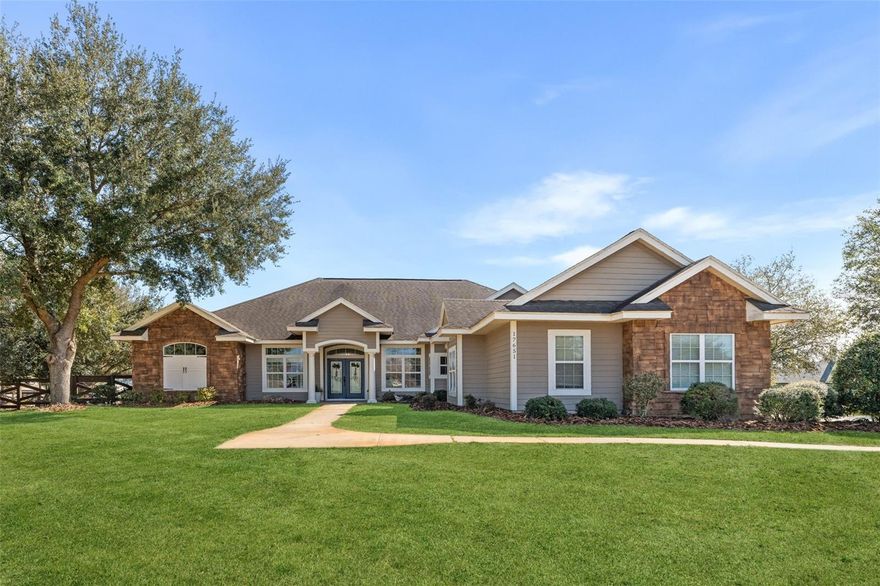 You will fall in love with this expansive 3100+ sq. ft. 4BR/3BA pool home, a custom Rutenburg built masterpiece in the distinguished gated community of Cinnamon Hill Estates. Enter through the double leaded-glass doors to be greeted by a formal living room boasting rich wood flooring, extensive crown molding, and a lighted tray ceiling. This elegance carries into the large formal dining room, which features an alcove for a buffet, a built-in niche, and continued wood floors. The stunning chef’s kitchen offers solid wood cabinetry, stainless appliances, a separate island, and a large bar with a dedicated bar sink, double wall ovens, and elegant under-cabinet and soffit lighting. This space flows into the light-filled breakfast nook and a spacious family room, where wood flooring and a cozy fireplace create an inviting atmosphere with beautiful views over the expansive 1+ acre lot. The private Owners Suite serves as a true retreat, offering property views, an expansive walk-in closet with abundant storage, a 3-way dressing mirror, and a spa-like bath with dual vanities, a jetted tub, and a walk-in shower. The home further provides three additional bedrooms, two additional baths, and a massive 3-car garage. For ultimate peace of mind, a brand new roof will be installed prior to closing. Practicality meets luxury in the oversized laundry/mud room, complete with a utility sink, folding table, and ample storage. Step outside to a backyard paradise featuring a large lanai that opens to a huge pool with a tanning ledge, all surrounded by stylish pavers and additional covered outdoor living space. The sprawling acre of land is dotted with shady trees and leads to a private firepit further back in the yard, making it the ultimate setting for both relaxation and grand-scale entertaining.