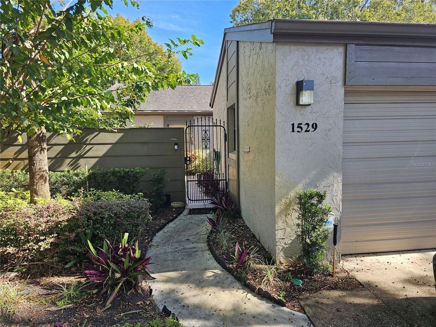 Highly desired Lake of the Woods end unit town home, single story with 2 car garage. This home was well taken care of for over 20 years by the prior owner. It is move-in ready and appropriately priced to sell considering some outdated cosmetics. Tile throughout the unit, open floor plan with high vaulted ceilings.