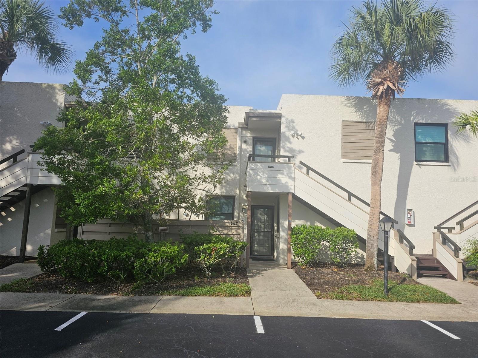 Second-Floor Pond View Retreat Near IMG & Beaches. Welcome to this inviting 2-bedroom, 2-bath second-floor condo, where tranquil pond views and comfortable living meet an unbeatable location. When you walk in, the kitchen greets you first, complete with a convenient pass-through window to the dining area and an in-unit washer/dryer tucked neatly into a closet, making daily living effortless. From there, the space opens into a cozy living/dining combination, creating a comfortable setting for everyday living and entertaining. The master bedroom, furnished with a plush king bed, includes a private bath with a tub/shower combination. The guest bedroom is set up as a cozy den, featuring a brand-new sofa sleeper and its own ensuite bath with a walk-in shower—perfect for visiting family or friends. Enjoy year-round comfort in the enclosed Florida room, where a table, chairs, and a dedicated reading nook overlook the peaceful pond—the ideal spot for morning coffee or an afternoon escape. This friendly community offers swimming pools and tennis courts, and is just minutes from IMG Sports Academy, State College of Florida, shopping, dining, medical facilities, and the gorgeous Gulf Coast beaches. Offered furnished for your convenience—just bring your suitcase and settle into the Florida lifestyle!