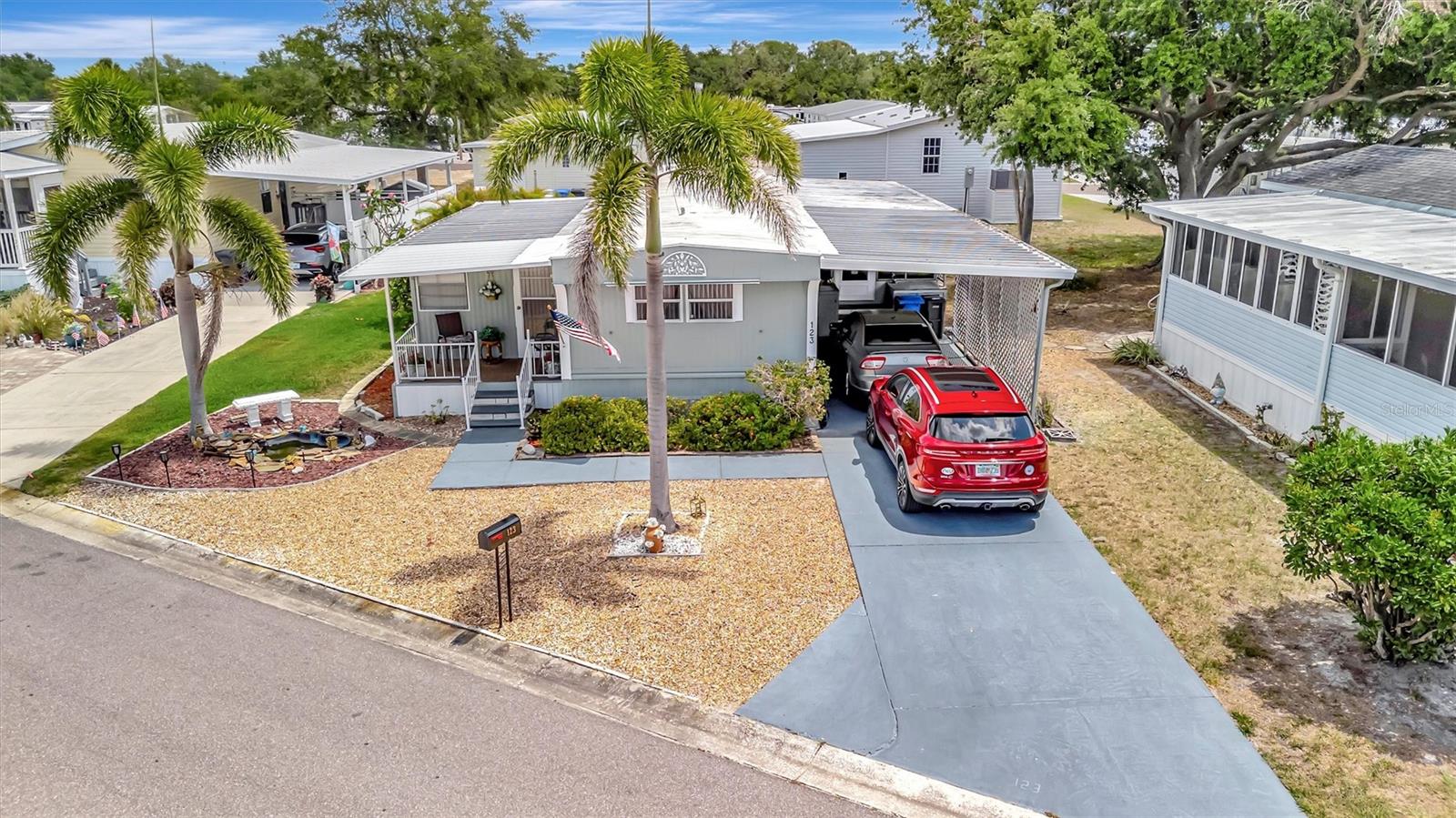 Welcome to Caribbean Isles Residential Cooperative. This home is Turnkey, bring your toothbrush and move in as this home comes with everything from plates and glasses to your couch, chairs and beds with open concept, 2 bedrooms & 2 bath & a Bonus Room that is Beautifully decorated. Large eat-in Kitchen with the Laundry just off the Kitchen and down the hallway. The Primary Bedroom has a large Built-in Closet with an Ensuite. Great Screened Patio to just sit and watch the world go by. The owner has installed a small water feature in the front with the soothing sound of running water. The home is low maintenance and well-maintained. Caribbean Isles Residential Cooperative is a highly desired community to live in. It is a VERY Active 55+ community. From Shuffleboard and Bocce Ball to Corn Hole and Horseshoes. We welcome Golf Carts and several times a year we gather and decorate for Parades. The Clubhouse is used for Dances, Games, Dinners and more. In the Clubhouse we have a well-stocked Library and a large Craft Room. The Game Room has 3 Billiard Tables, 2 Poker Tables, a Bar Shuffleboard with 2 Dart Boards. Don't miss this opportunity.
