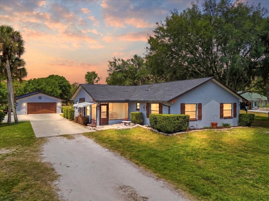 Set on 1.14 acres in Canaveral Groves on a dead end street, this 4 bedroom, 2.1 bath home offers the space, privacy, and flexibility you've been looking for. Inside, the open layout features soaring cathedral ceilings and a wood-burning fireplace that anchors the living space. Enjoy the outdoors from the screened front porch or the oversized back patio.The standout feature is the oversized detached 2-car garage with a private in-law/ young adult suite, complete with its own A/C, water heater, full bath, and mini kitchen, ideal for multi-generational living, guests, or extra income potential. The property is set up with two wells, plus electric and water at the back for RV hookup, along with a storage shed. Plenty of room to spread out and make it your own. Major updates are already in place, roof (2019), A/C (2020), Water Heater (2020) and 200-amp panel (2020).