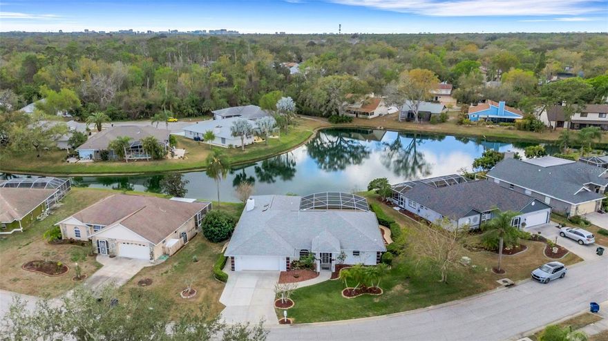 LET THE SUN SHINE IN!  Come explore this waterfront beauty in Cedar Creek in North Sarasota, where serene pond views and indoor-outdoor living come together beautifully. This 3-bedroom, 2-bath home offers approximately 2,100 square feet of living space on a generously sized lot perfectly positioned to capture water views from nearly every room.  Double front doors open to a vaulted-ceiling living room with sliders that immediately draw your eye to the sparkling salt water pool and wide pond view beyond. The natural light pouring in creates a warm and inviting first impression that only gets better throughout the home.   Designed for both comfort and entertaining, the layout includes separate living and dining rooms plus a comfortable family room featuring a stone wood-burning fireplace and a full wall of custom built-ins adjacent to the kitchen. The bright kitchen offers shaker cabinetry, dark granite countertops, a pass-through window to the lanai, a newer dark stainless GAS range giving you the convenience of propane cooking — a true chef’s dream.  All three bedrooms feature walk-in closets and mounted 50+” TVs, with the 2nd bath featuring a door to access the pool area.  The spacious primary suite includes a custom-designed closet maximizing every inch of space and sliding glass doors that open directly to the lanai and salt water pool.  Outdoor living shines with four sets of sliders leading to the pool area, creating seamless indoor-outdoor flow. The large lanai is under roof, offering plenty of room to add an outdoor kitchen and dining area. The screened pool enclosure was replaced in 2024, and poured sidewalks surround the home for clean, easy access all around.   
For peace of mind, major improvements include • Roof replacement in 2021 • New A/C and water heater in 2022 - there are so many features here, get the full list!  Low HOA fees of just $200/quarter and no CDD make this home even more attractive.  Location is here as this community is just 4 miles from UTC and all there is to do - restaurants, shopping, Benderson Park, and tons more close by! Don't let this opportunity pass you by!