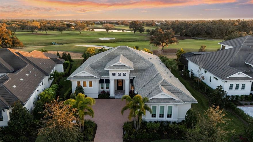 Experience the pinnacle of Sarasota luxury real estate in this masterfully composed estate within The Founders Club, just a short walk to the clubhouse amenities. Situated on the tenth hole, this Lee Wetherington Mainstay Platinum residence offers a rare vantage point with unobstructed views spanning four holes across the championship golf course.

The residence serves as a benchmark for country club living, where coastal sophistication meets meticulous architectural detail. Professionally designed to create a serene atmosphere, the home features an array of high-end finishes, including shiplap wall and ceiling treatments, reclaimed wood accents, and custom recessed LED downlighting. Distinctive design elements elevate every room, from the grasscloth and Thibaut wallcoverings to the designer Schumaker wallpaper and custom linen window treatments.

The open-concept floor plan includes three bedrooms, an office and a versatile bonus room with hardwired Hunter Douglas Silhouette blinds. The guest wing is equally refined, featuring a bathroom adorned with coastal fish scale tile and glass enclosures. The kitchen features a Fulgor natural gas cooktop, a built-in GE Monogram refrigerator with integrated cabinetry panels, and GE Café appliances. A dedicated bar area with Cambria quartz counters and a wine cooler provides a seamless transition to the great room, anchored by a Dimplex linear fireplace recessed into a shiplap feature wall.

The primary wing offers a private sanctuary with a custom closet outfitting, motorized shades, and a spa-like bath with light-up Kohler medicine cabinets. Technological integration is paramount, including a garage with an EV charger. 

The outdoor living space is a coastal dream, finished with Diana Marble decking and a saltwater pool featuring an automated autofill system and natural gas heater. A fully equipped outdoor kitchen with steel cabinetry and a Coyote natural gas grill provides the ultimate setting for the Sarasota sunset lifestyle in one of Florida’s premier golf destinations.