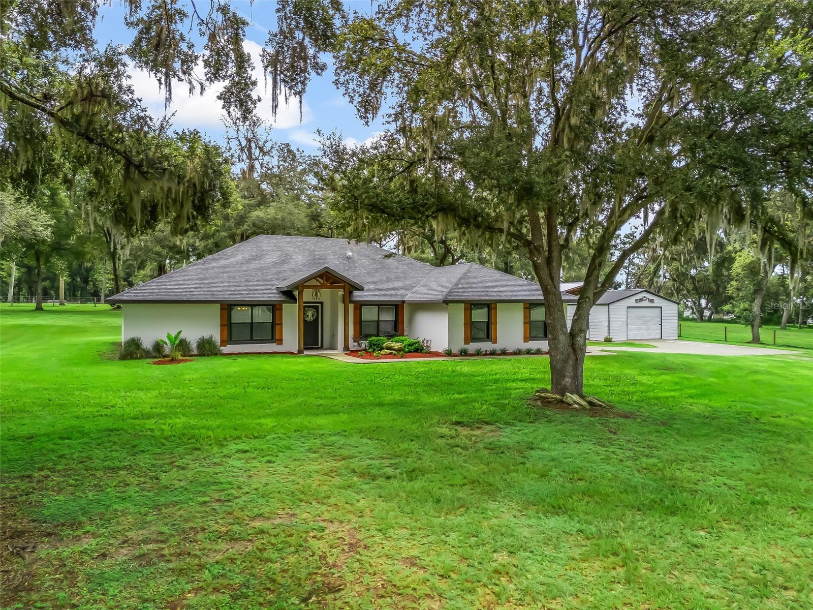 Welcome to your dream property! This gorgeous block home, set on 24.46+/- peaceful acres, combines modern elegance with country charm. Inside, you’ll find bright, open living spaces with crisp, clean finishes, tile flooring in the main areas, and plush carpet in the bedrooms for comfort. The owner’s suite is truly a retreat—featuring a tray ceiling with a cozy sitting area, dual walk-in closets, and a private hallway leading to the luxurious ensuite. The spa-like bathroom boasts a walk-in tiled shower and a relaxing soaker tub, perfect for unwinding after a long day. The heart of the home, the kitchen, offers a bar for casual dining, a sunny breakfast nook, and plenty of space for gathering. Step outside to the screened-in back porch where you can sip your morning coffee while enjoying serene views of deer and playful fox squirrels right in your backyard. Beyond the home, the property is well-equipped with a 24x20 shed and a spacious pole barn—ideal for storing equipment, tools, or starting your next hobby farm. With room to roam and space to breathe, this property gives you the best of both worlds: a modern home in a private, natural setting. I-75 is only a few miles away. Groceries, shopping and dining are all within a 15 minutes of this retreat. Don’t miss the opportunity to make this beautiful estate yours. Schedule your private showing today and experience the lifestyle you’ve been dreaming of! You can also purchase this property with only 10 acres, if you desire.