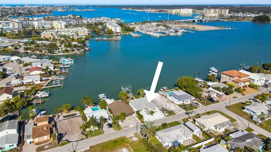 An extraordinary opportunity to finish the transformation of a true Madeira Beach waterfront gem. Perfectly positioned along open water in the Madeira Cove of Boca Ciega Bay, this standout property captures the essence of Florida coastal living and offers the rare chance to create something truly special, whether through a thoughtful renovation or a brand-new custom build. The waterfront features alone are irreplaceable: a seawall, private dock, two boat slips, and a 16,000 lb boat lift set the stage for effortless boating, world-class fishing, and unforgettable evenings watching vibrant sunsets and dolphins right from your backyard. Inside, the layout was designed with flexibility in mind. Two primary ensuite bedrooms with separate entrances offer endless possibilities: ideal for an in-law suite, private guest quarters, or income-producing rental units. The home is wheelchair accessible and has the potential to be converted into a duplex, unlocking significant rental or multi-generational living potential. Recent upgrades provide a strong foundation for the rebuild, including new recessed lighting throughout, a new A/C system, new electrical panel, new electric water heater and a roof replaced in 2017. The home is also elevated nearly two feet above the slab with a crawl space underneath, a valuable structural feature for coastal living. Location is everything, and this one delivers: just a 0.25-mile walk straight to public beach access, plus walking distance to local bars, restaurants, and coffee shops, front seat access to the Madeira Beach boat parades, and fireworks, offering the ultimate live-where-you-vacation lifestyle. The property was flooded during Helene, and was quickly opened up and cleaned out. Due to the elevated nature of the home, the house flooded less than the surrounding homes. Whether you envision restoring the existing structure or starting fresh with a custom waterfront masterpiece, this is a rare chance to secure a prime canal-front lot in Madeira Beach and bring a high-potential property back to life.