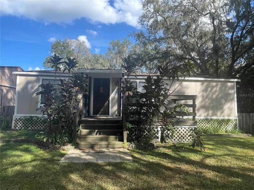 A little bit of country right in the middle of Wesley Chapel! If you’re looking for peace, quiet, and room to breathe while still being close to everything, this completely renovated 3-bedroom, 3-bath home delivers. Full renovations create a clean, comfortable feel throughout. Enjoy sunsets from the elevated front porch, then step inside to a spacious main living area that flows into the kitchen prep space and cozy breakfast nook overlooking the backyard and conservation. The decorative stone fireplace with electric logs adds warm ambiance on cooler nights. The split floor plan offers generously sized bedrooms with plenty of privacy, plus an additional room in the rear that works perfectly as an office, playroom, or workout space. Outside, the fenced yard shaded by mature oak trees features a fire pit and open patio—great for relaxing or entertaining. Tucked away in a peaceful setting yet just minutes from Wesley Chapel, Dade City, Zephyrhills, shopping, dining, and everyday conveniences. Rent includes water (well) and septic, and a washer and dryer are provided for tenant convenience only.