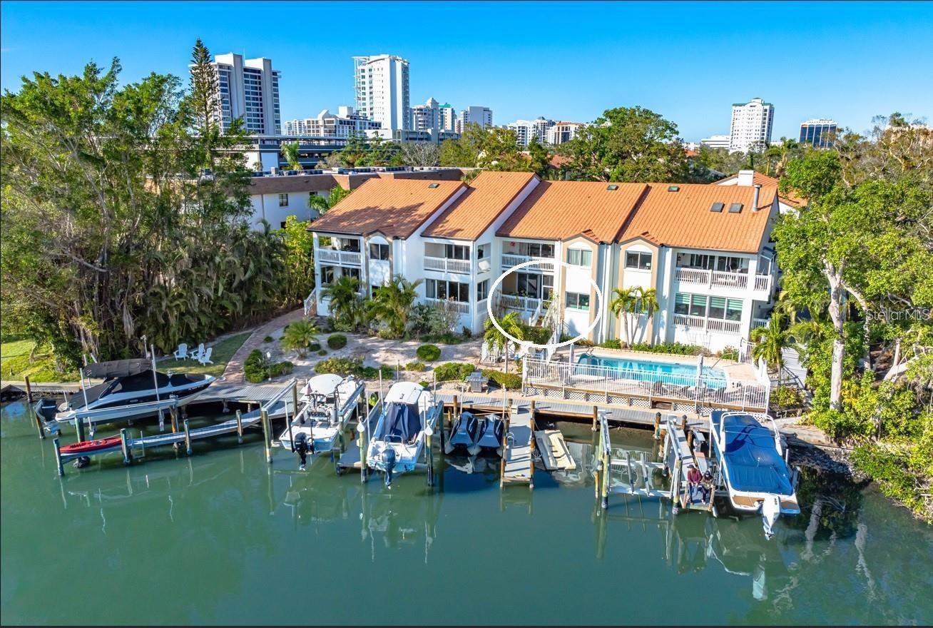 Experience living on the water with your deeded dock. Boat size up to 27ft. Waterfront fully furnished ground-floor condo in Hudson Landings. This rare west-of-the-trail unit features 3 bedrooms, 2 bathrooms, and a deeded dock, offering direct access to Sarasota Bay and the Gulf of Mexico. Enjoy serene water views from the open patio, where you can start your morning with coffee or unwind at the end of the day. Key features include high ceilings, hurricane windows/ sliders, granite countertops, a breakfast bar, tile flooring, and stainless steel appliances. The spacious master bedroom and patio both overlook the canal, allowing you to keep an eye on your boat. This southern-facing condo is bathed in natural light and offers a seamless blend of style and functionality. Hudson Landings is a community of just 12 residences, perfectly situated in a private, peaceful location near downtown Sarasota, Selby Gardens, and the Marina. With a heated community pool and a lifestyle tailored for water enthusiasts, this is an incredible opportunity to live downtown while enjoying the tranquility of waterfront living.