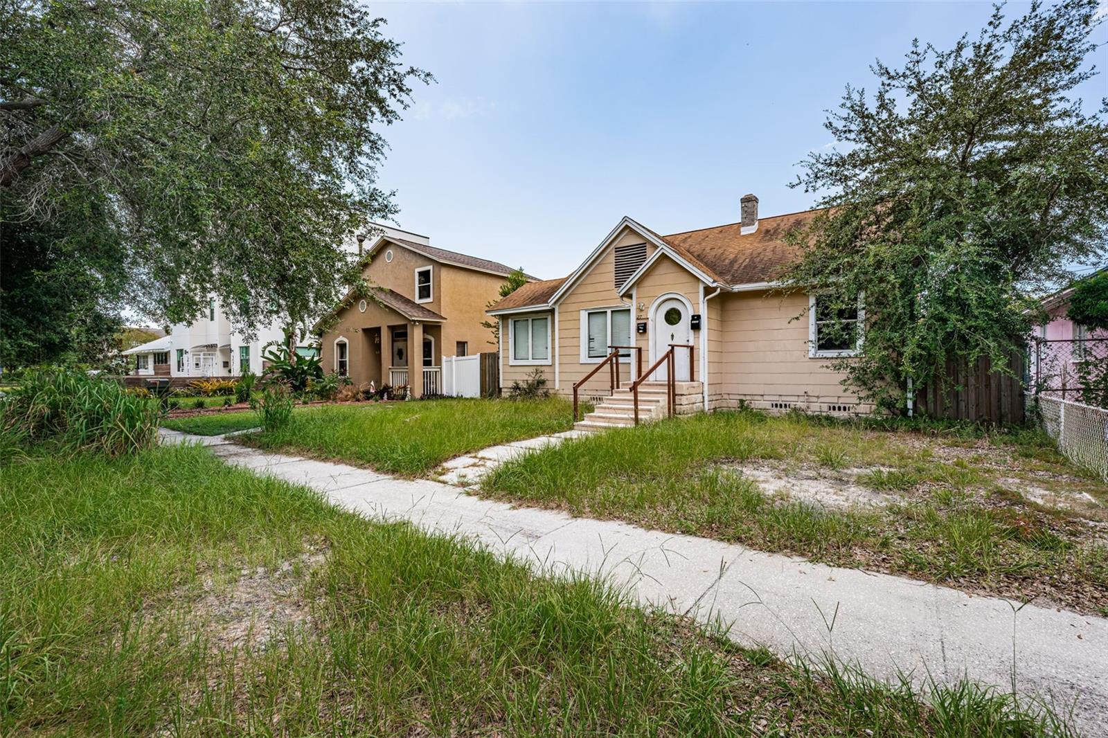 Investor Alert! Rare opportunity to renovate or redevelop in the heart of St. Pete’s vibrant Grand Central District. This property features an existing 4-bedroom, 2-bath, 1,510 sq ft main home plus a detached garage with a 532 sq ft, 2-bedroom, 1-bath apartment above. The main residence offers a spacious layout with two bedrooms and one bath on each floor and is ready for a full renovation. The garage apartment has been consistently leased, providing immediate income potential. Flexible CRT-1 (Corridor Residential Traditional) zoning allows for a variety of development possibilities. Just one block from local favorites like Bandit Coffee, Casita Taqueria, Wild Child, and Baba, and with easy access to the SunRunner, this property is perfectly positioned for future growth. Bring your vision and transform this two-unit gem in one of St. Pete’s
most sought-after neighborhoods.