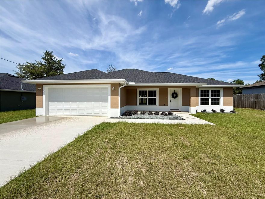 Welcome to Your Peaceful Retreat — Where Modern Design Meets the Beauty of Nature. Discover this stunning newly constructed home offering a thoughtfully designed split floor plan that delivers both privacy and a warm, inviting flow for everyday living. From the moment you step inside, you'll be welcomed by an open-concept living, dining, and kitchen area bathed in natural light, showcasing elegant quartz countertops, stainless steel appliances, and abundant cabinetry — ideal for both everyday gatherings and effortless entertaining. The private master suite is a true sanctuary, featuring a tray ceiling, a spacious walk-in closet, and a luxurious ensuite bath complete with a dual vanity quartz countertop and a walk-in shower. An indoor laundry room with built-in cabinetry adds everyday convenience right where you need it. On the opposite side of the home, two additional bedrooms — each adorned with elegant tray ceilings — offer comfort and flexibility for guests, family members, or a dedicated home office, complemented by a conveniently located linen closet. Step outside to a generous backyard brimming with endless potential to design your own private outdoor oasis. Perfectly situated near the scenic shores of Lake Weir and just a short drive to Downtown Ocala, this home offers the ideal balance of peaceful living and easy access to shopping, dining, and recreation. This is more than a house — it's a beautiful place to call home. Schedule your private showing today!