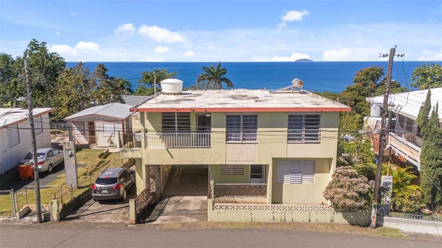 Panoramic ocean views from this rare multi-unit fixer-upper is a true diamond in the rough. Wake up to the sound of waves and unwind each evening with breathtaking sunsets that paint the sky in brilliant hues of gold, pink, and crimson.This property offers multiple units, making it an exceptional opportunity for investors, developers, or visionaries looking to create a stunning coastal retreat. Each unit captures sweeping water views, refreshing sea breezes, and abundant natural light. With solid bones and endless potential, this is your chance to renovate and customize while significantly increasing value.Imagine transforming these spaces into modern coastal residences, vacation rentals, or a boutique seaside escape — all in a location where the ocean feels like your backyard.

Opportunities like this are rare: incredible views, income potential, and the chance to design your dream coastal investment in the highly renowned neighborhood of Puntas, Rincon. The top floor has 3 bedrooms with an office/den that connects the primary bedroom to the living room. It also includes a kitchen, laundry room and full bathroom, plus a massive open terrace off the back of the house ideal for watching the iconic sunsets of Western Puerto Rico. Downstairs is an in-law suite with 2 bedroom, 1 bathroom, living room, kitchen and attached carport with additional storage room (which could be converted to another bedroom). Off the back of the house is endless potential with a covered area that is approximately 520 SqFt (20ft X 26ft) with an extremely high ceiling to allow for multiple possibilities. Just behind this covered area is the remnants of a workshop that is approximately 534.75 SqFt (15.5ft X 34.5).  Although this old workshop is uncovered it still has half of the walls standing and the other half has 3ft high cinderblock walls, giving the property the potential of four separate units.

Bring your contractor and your imagination — the sunsets are already included.