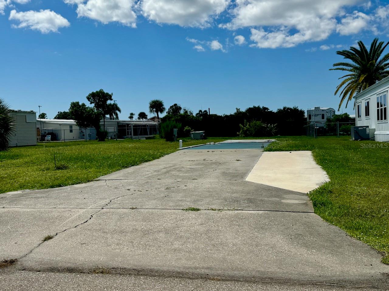 Priced to sell! Check out this wonderful lot with cement pad ready for your new home in the great location of Holiday Mobile Estates, a premier 55+ community. You own your own land and the HOA is optional. No CDD fees make this a super affordable option. Just UNDER 5 MILES TO THE BEACHES of Manasota Key. The optional HOA fee is only $35 a year and optional amenity membership of only $300 a year provides access to the community pool, tennis, pickleball, shuffleboard and bocce ball courts PLUS Clubhouse with a lot of fun community events and happenings. Many shopping and dining options nearby.