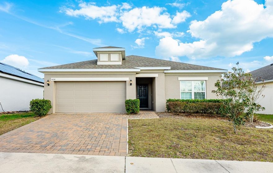 Built in 2018 and thoughtfully designed for modern living, this spacious 4-bedroom, 2-bath single-story home in the Preserve at Sunrise offers the comfort, flexibility, and OPEN CONCEPT you have been searching for! High ceilings, abundant NATURAL LIGHT, and TILE FLOORS throughout the main living areas create a bright, welcoming feel from the moment you step inside. The heart of the home features an open living, dining, and kitchen layout ideal for both everyday living with family and entertaining friends. The home chef will appreciate the modern kitchen showcasing rich cabinetry, sleek countertops, STAINLESS STEEL APPLIANCES, ample storage, and seamless sightlines into the main gathering spaces. Sliding glass doors extend the living area outdoors to a SCREENED LANAI, while a paver patio and nicely sized backyard provide additional space for relaxing, grilling, or enjoying Florida evenings. A desirable 3-WAY SPLIT BEDROOM floor plan adds privacy and versatility; with your PRIMARY SUITE is tucked away at the back of the home, offering a peaceful retreat complete with a large WALK-IN CLOSET and a well-appointed en-suite bath featuring dual sinks, a walk-in shower, and a window that fills the space with light. Bedrooms two and three are positioned at the front of the home with a full guest bath between them, while bedroom four sits along a separate hallway near the laundry room – perfect for a home office, guest room, or quiet flex space. Located in the welcoming Preserve at Sunrise, residents enjoy access to a COMMUNITY POOL and playground while living just outside the hustle and bustle of Orlando. Convenient access to nearby FL-33 makes commuting easy and connects you to shopping, dining, recreation, and the many area lakes and outdoor activities that make Groveland such a desirable place to call home. Spacious, bright, and MOVE-IN READY, this home blends modern design with everyday functionality in a great community - call today to schedule a tour!