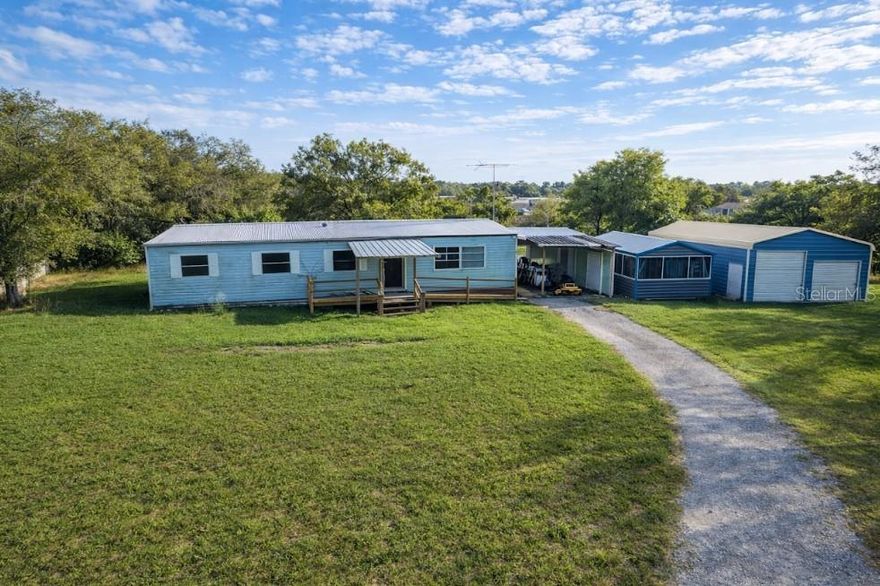 Discover incredible potential on this spacious 0.92-acre property in Zephyrhills, Florida! Tucked away on a private end road, this unique opportunity offers space, privacy, and versatility—all while being conveniently close to major growth areas and city amenities.

The main residence is a 4-bedroom, 2-bathroom mobile home featuring an open-concept layout with a designated laundry area. The kitchen expansion is currently underway, with plumbing and square footage improvements in progress (permits in process), giving buyers the opportunity to customize and add value. Enjoy outdoor living with a rear porch, plus a carport upon entry and a nearby storage shed.

This property stands out with multiple additional structures, including a large enclosed garage/workshop with approximately 12-foot height clearance—ideal for mechanics, storage, or business use—as well as an additional screened shed for added flexibility.

At the rear of the property, you’ll find a second dwelling currently under construction. Designed as a 2-bedroom, 1-bathroom home with an open layout, it is being sold as-is with open permits in progress. The sale may include building materials and permit applications, allowing the next owner to complete the project and create a valuable income-producing unit or guest home. Please note: pricing may increase as construction progresses.

Location & Investment Appeal:
Ideally located just 15–20 minutes from Wesley Chapel and New Tampa, and within convenient reach of Tampa, this property offers the perfect balance between privacy and accessibility. Nearby access to public transportation routes in Zephyrhills and Wesley Chapel adds to its convenience. Plus, you’re within driving distance to Clearwater’s beautiful beaches, offering a desirable Florida lifestyle.

With the rapid growth of the surrounding areas, this property presents a strong opportunity for investors or homeowners seeking rental income potential. The combination of land, multiple structures, and proximity to expanding city centers makes it easier to attract tenants and maximize long-term value.

Whether you’re looking to create a multi-generational living setup, a rental property, or a live/work space, this property offers endless possibilities in a fast-growing location.

Select images have been virtually staged to help you envision the true potential and future possibilities this  property can have