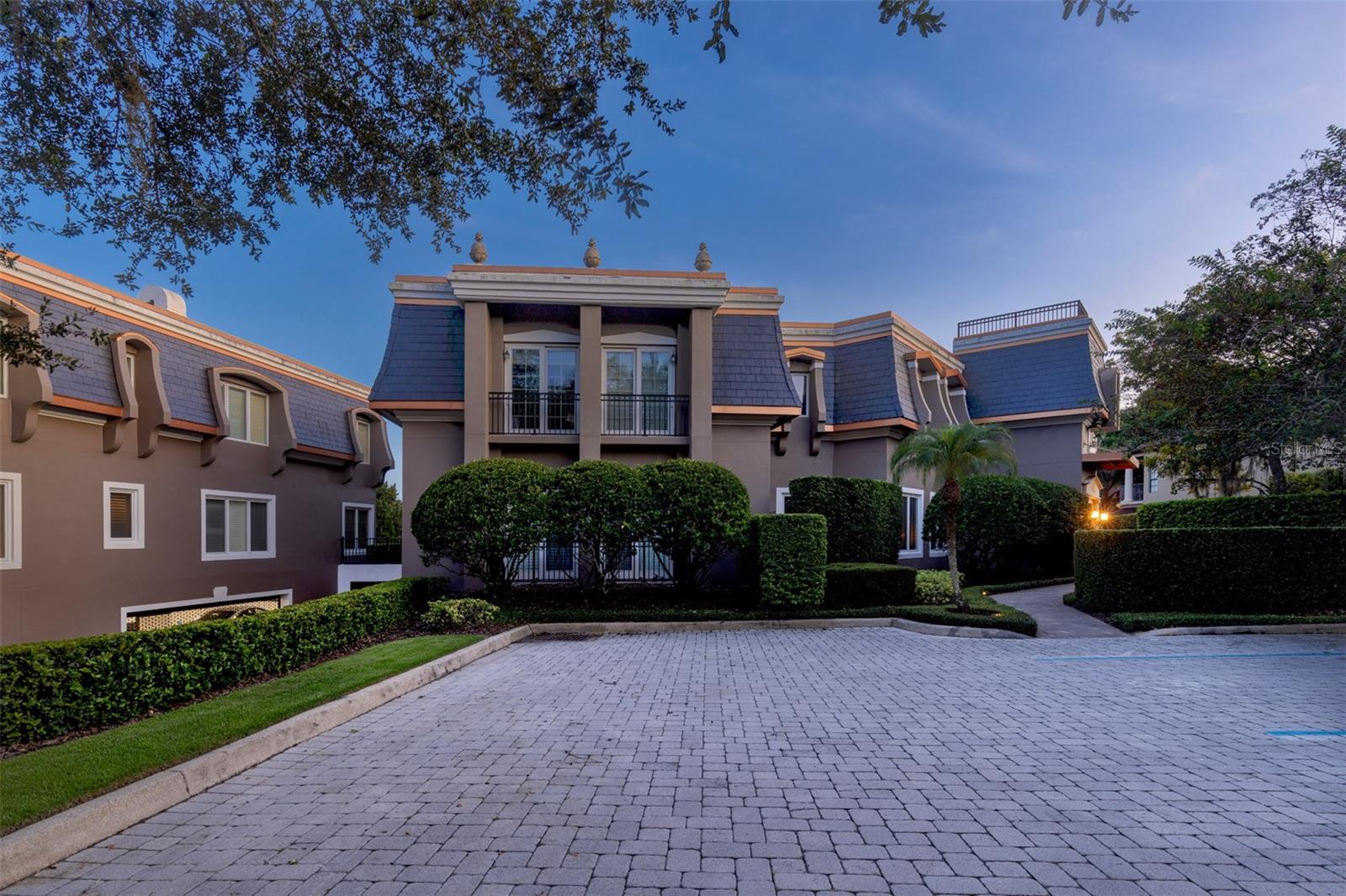 A unique opportunity to own a direct waterfront condominium in downtown Winter Park on Lake Virginia with the finest views, in exclusive Perle Du Lac. This one owner unit is wrapped on a spacious corner, flanked with windows and drenched in light, and exudes understated luxury. This three-bedroom three-bath split bedroom plan condominium boasts nearly 2,700 square feet of open spaces for modern function. A marble floor foyer and warm wood floors and volume ceilings invite you into a neutral palette and timeless finishes. A European SieMatic luxury kitchen with beautifully crafted solid wood cabinetry, stainless appliances and center island with solid Corian counters, which open to dining space with wine storage and dry bar, for ease of entertainment. Living spaces overlook the lake and seamlessly blend into balcony with second-floor unobstructed views of Lake Virginia overlooking the Windsong preserve and a long view to soak in the Chain of Lakes sunsets. Primary bedroom is lakefront with doors to patio and large custom European closet cabinetry, and primary suite is appointed in Italian Carrera marble add to the elegance of the finishes. Unit includes a deeded boat slip to enjoy lake life through the Venetian-style canals connecting five lakes. Other highlights of the community include secure entrance with double gates for convenience, secure buildings, community pool, underground parking with elevator to units, storage, greenspace and ample parking. Walk to Park Avenue where restaurants and shopping are abundant, art festivals, community events and more. Indoor laundry, enhanced lighting package, custom window treatments add to the list of features. Perle Du Lac neighbors Rollins College and president of Rollins home, there is not a more breathtaking setting than Perle Du Lac. Fully gated with underground parking and community pool making everyday life simple with everything within arm’s reach. A rare opportunity for the most discerning buyer.