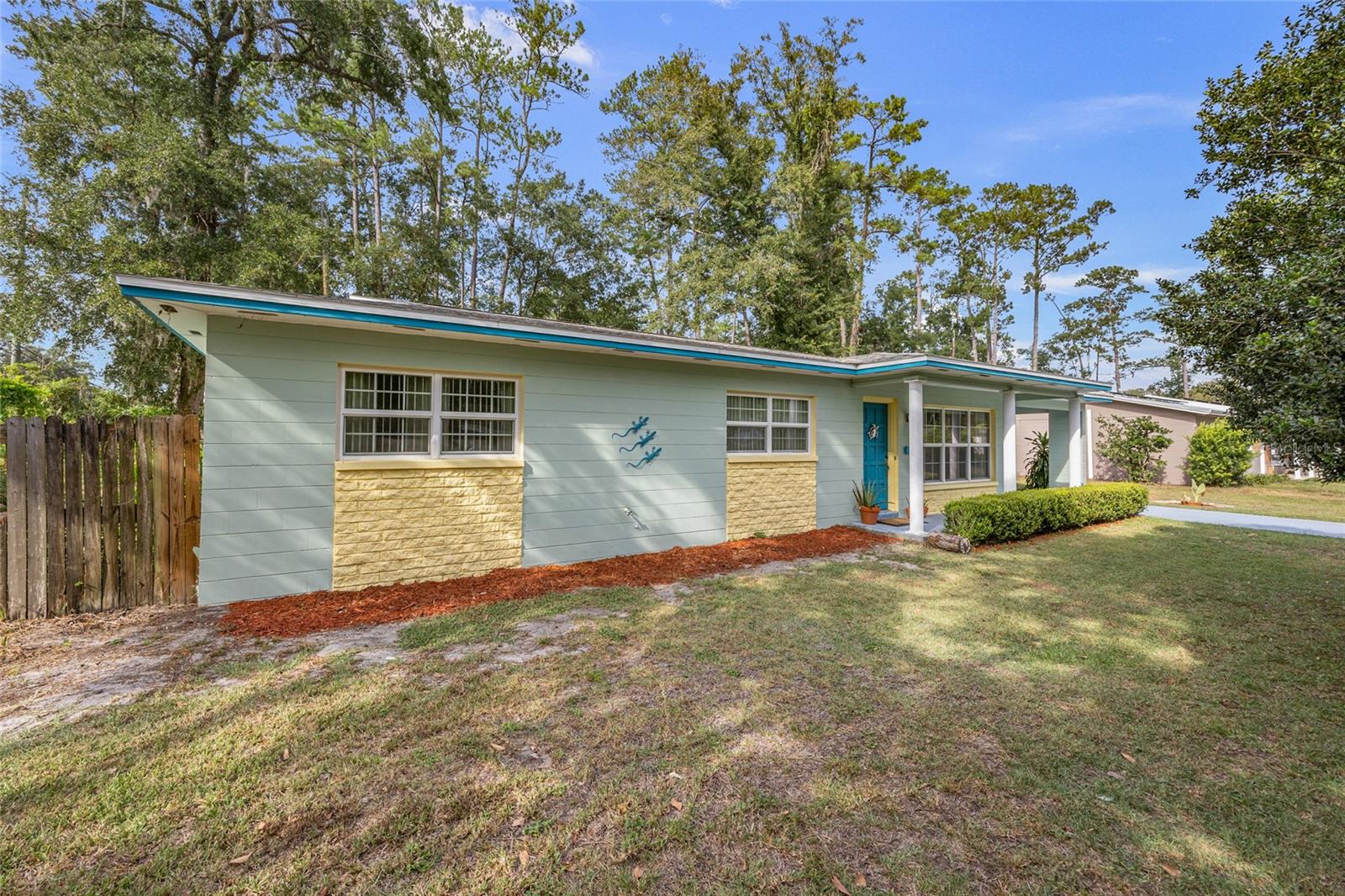 Perfectly positioned on an oversized corner lot, this 3-bed, 2-bath concrete block home is just minutes from University of Florida! Spanning 1,616 sq ft, this residence features a thoughtfully designed floor plan and an enclosed porch, making it ideal for entertaining year-round. Inside, the home is filled with natural light streaming through large windows. The living room, with its elegant marbled tile flooring, flows seamlessly into the light and bright kitchen. Adjacent to the kitchen is the dining room that opens to the spacious family room with tranquil views of the lush backyard, complete with mature plants and fruit trees. The home boasts no carpet, with easy-to-maintain tile in the living areas and bathrooms, and warm wood floors in the hallway and bedrooms. The primary suite includes double closets and an ensuite with walk-in shower. Two guest bedrooms and a full guest bath with a tub/shower combo provide privacy and comfort to family members, guests, or roommates. A notable feature is the replacement of the sewage system in 2024. Located in a desirable NW Gainesville community with no HOA, this home is the ultimate in convenience. It’s just minutes away from the University of Florida, Santa Fe College and the YMCA, with a bus stop, I-75, and US 441 nearby. Hospitals, shopping centers, restaurants, nature parks, and bio-tech research and development parks are all within easy reach. Whether you are looking for an investment or a comfortable place to settle down, this solidly built home is a must see. Call us today!