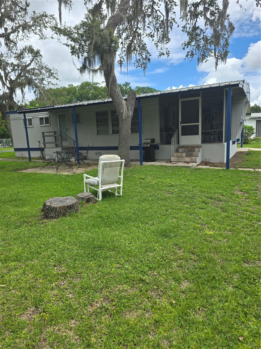 This very spacious 2 bed, 1.5 bath home is nicely updated, and located on a beautiful lot. The easy to clean ceramic tile in the main areas adds to the beauty of this home and the other areas have had vinyl floors installed. The home is mostly furnished, so you would be able to move right in. It is located in the 55+ resident owned community of Griffwood, which is on Lake Griffin, part of the Harris Chain of Lakes. The current owner has a rented boat slip with a lift, and it could transfer with the home if the buyer wanted to purchase the boat lift. There is also a heated pool, game courts including shuffle board and bocci ball, a clubhouse that is used for many meals, activities and games, coin laundry, a library and more. There have not been many homes for sale in this community, so don't hesitate to come and check it out!