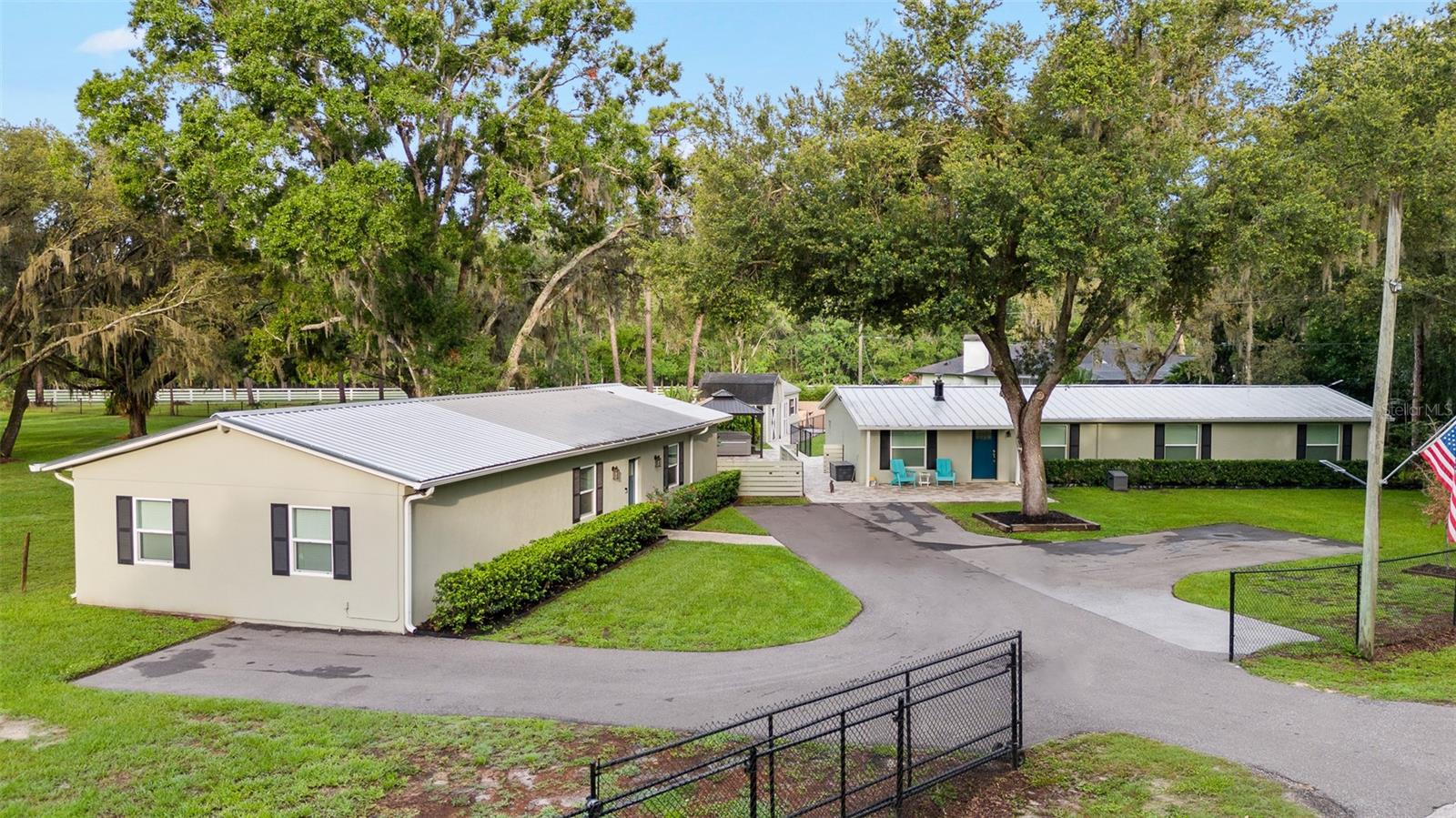 One or more photo(s) has been virtually staged. What an Incredible Property!!! 3/4 Acre in a Peaceful Country Setting! Located on a beautifully landscaped and totally fenced lot, there is no HOA or CDD and is perfect for you to enjoy. There is a second structure for recreation or for your office space. THE SECOND STRUCTURE IS NOT BEING MARKETED AS HABITABLE SPACE.
The home is 3BR/2BA approx. 1,516 sq. ft., crown molding, wood-cased windows, oversized walk-in closet, and luxurious ceramic tile bath in the primary suite. Gourmet kitchen has quartz countertops, solid wood cabinets, upgraded stainless steel appliances include double oven, range, refrigerator, dishwasher, and garbage disposal. Inside laundry with washer & dryer included. 342 sq. ft. screened, roof-covered lanai across the back of the home overlooking the privately fenced back yard. NOTE: BLACKTOP PARKING AREA COMPLETED AFTER PHOTOS TAKEN! Ample parking space for multiple vehicles.
Second structure has 1,416 sq. ft. In addition to main area here, could be the perfect office for your business, or a great recreation area and there are two additional rooms with ceiling fans. There is plenty of room for that pool table or any other entertainment systems. The oversized double-head shower, double vanities, and storage closet complete the bathroom. Inside laundry with washer and dryer included. Upgrades & features in home and second structure include luxury vinyl tile flooring, newer electric, plumbing, AC, and windows, metal roofs, large new septic system (2025), deepened well (2025). Bring your BOATS, RV’s and any other toys you may have. Outdoor Living includes: huge private and fenced backyard, brick paver gazebo area and outdoor Jacuzzi, additional storage shed and separate workout area. BRICK PAVER WALKWAY TO HOT TUB, SHED AND WORKOUT ROOM.
Located just minutes from shopping, dining, and schools ... this property offers the best of peaceful country living with modern convenience. Easy to show — please allow 2 hours’ notice for all showings.