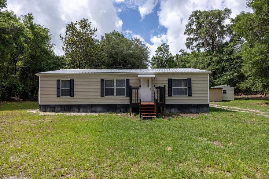 Welcome to this beautifully remodeled 3 bedroom 2 bathroom home situated on 4.5 acres. Nestled in the tranquil neighborhood of Spanish Trace, this serene location offers peace and privacy, making it an ideal spot to settle down and create your own haven. The home was fully remodeled in 2025 with high-end materials and craftsmanship. Step inside to discover a thoughtfully designed layout featuring a spacious living room perfect for both entertaining and relaxing, accented by natural light pouring in through windows. The kitchen features new stainless-steel appliances and ample cabinet storage. Adjacent to the kitchen, a laundry room with plenty of room for a washer, dryer, and extra storage racks. The primary bedroom is spacious and includes a walk-in closet. The primary bathroom has been fully remodeled, with a new vanity and step-in shower. This home has a split floor plan, providing a living room and dining room perfect for entertaining and relaxing. On the other side of the home, there are two additional bedrooms and a fully remodeled bathroom, providing ample accommodation, luxury vinyl flooring, and ample closet space. These additional bedrooms provide versatility for guests. Numerous updates have been made in the last few years, including a full house remodel in 2025: new interior paint, exterior skirting, new vinyl flooring and trim, new HVAC, new fans, stainless steel appliances, and both bathrooms fully remodeled. Additionally, the home has a newer covered metal roof. Outside, revel in the beauty of a fully fenced 4.5 acre property with a repainted back deck and storage shed. The property is mostly cleared land with some trees for added privacy. The property is conveniently located just 10 minutes from downtown Chiefland and 30 minutes from Cedar Key, which offers ample options for dining, shopping, and hospitals. This is a one-of-a-kind property, so call today to schedule a showing!