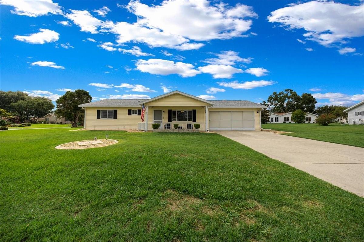 Graciously positioned on a .3-acre corner lot in Spruce Creek South, this updated 2-bedroom, 2-bath Evergreen model has a strong street presence with added breathing room in one of Summerfield’s premier 55+ golf communities. From the front, a curbed landscape frames the home with neat edges and inviting charm, and the wide front porch creates a welcoming entry with plenty of room to sit, stay awhile, and quietly take in the neighborhood.
Inside, porcelain tile extends across the main living areas met by fresh paint, Bali window treatments, updated 6-panel doors, and new AC vent covers + ceiling fans in every room. Crisp and bright, the kitchen is smartly arranged with granite counters, stainless appliances, and a built-in microwave to suit the everyday cook.
Sliding doors from the dining room open onto a full-length lanai lined with vinyl windows and cooled by ceiling fans. It lives like part of the interior, with space that supports year-round use and adds flexibility to the home's overall layout.
The primary suite is spacious and serene, with a walk-in closet and renovated ensuite that includes soft-close cabinetry, granite surfaces, and a Bathfitter shower finished with classic subway tile. A generous guest room includes a walk-in closet and convenient access to a refreshed full bath with updated vanity, modern lighting, and a convenient tub-shower combination.
Storage and utility are quite exceptional here. The two-car garage includes a new opener with security camera, insulated panels, attic access via built-in ladder, and updated springs. At the back of the property, a separate golf cart garage with roll-up door offers space for hobbies or seasonal storage.
Recent improvements include a 2021 roof, 2023 HVAC, 2024 water heater, and a new electrical panel installed in 2025. The irrigation system, installed in 2022, is WiFi-enabled and fully operational. Kitchen appliances were replaced in 2023, with washer and dryer updated in 2024.
Septic inspected and pumped 2024. Termite inspection July 2025 with transferable warranty.
Spruce Creek South surrounds the Links Golf Course, an 18-hole, par-72 championship course designed by Terry Doss. Residents also enjoy access to a clubhouse, fitness center, pool, pub, library, billiards room, and an active schedule of social and recreational events. The community is located just minutes from The Villages, offering even more options for shopping, dining, and entertainment.