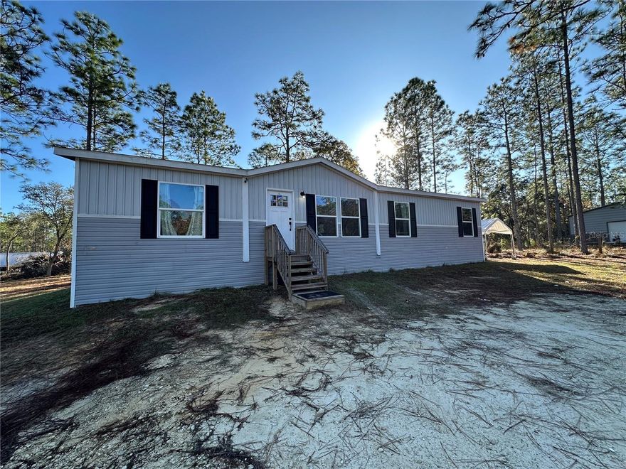 Beautiful mobile home (4 bed / 2 bath) on 2.5 acres in Williston Highlands Unit 7, offering the perfect blend of privacy, space, and functionality. This fully fenced property features two gated entrances, including access ideal for trucks, trailers, or heavy machinery, and even the possibility to split the lot. The home boasts an extra-spacious master bedroom, a luxurious master bathroom with a walk-in closet, and a bright open-concept living area. The land is cleared, with select mature trees left to provide shade and character, giving you a clean canvas for future plans. A rare find with room to grow—ready for your lifestyle, hobbies, or business needs!