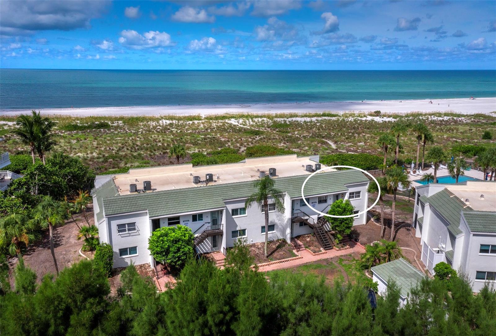 Experience elevated coastal living in this beautifully renovated, second-floor beachfront condominium, offering sweeping Gulf views and the tranquility that comes with a higher vantage point. Nestled within the intimate, gated community of Sea Pines on the serene north end of Longboat Key, this end-unit residence effortlessly blends updated sophistication with the soothing rhythm of the sea. This light and airy floor plan features two bedrooms, two full baths, and a flexible den that easily converts to a third sleeping area for guests. Designed with a relaxed, coastal aesthetic, the interior showcases neutral flooring and paint tones, stylish plumbing fixtures, updated lighting, plantation shutters, and solid surface countertops throughout. The kitchen is a true showpiece, offering Gulf views, modern cabinetry, sleek open shelving, shiplap accent walls, a statement tile backsplash, premium GE Café appliances, and a large pantry—perfect for any home chef.
The primary suite is a peaceful retreat with views of the Gulf and community pool, a generous walk-in closet, and a spa-style en-suite featuring a spacious walk-in shower. Step outside from either the living area or the primary suite onto a 26-foot screened lanai—ideal for morning coffee, al fresco dining, or simply unwinding to the sound of waves and the sight of spectacular sunsets. The guest suite offers its own en-suite bath and large walk-in closet, providing comfort and privacy for visitors. A full-size, side-by-side washer and dryer add everyday convenience. Sea Pines is a boutique complex of just 28 residences, offering a relaxed and secure lifestyle with gated entry. Amenities include a heated pool with lounging and dining areas, a private beach access path, tropical landscaping, outdoor grilling stations, and a pet-friendly atmosphere with strong rental potential. Don’t miss this rare opportunity.