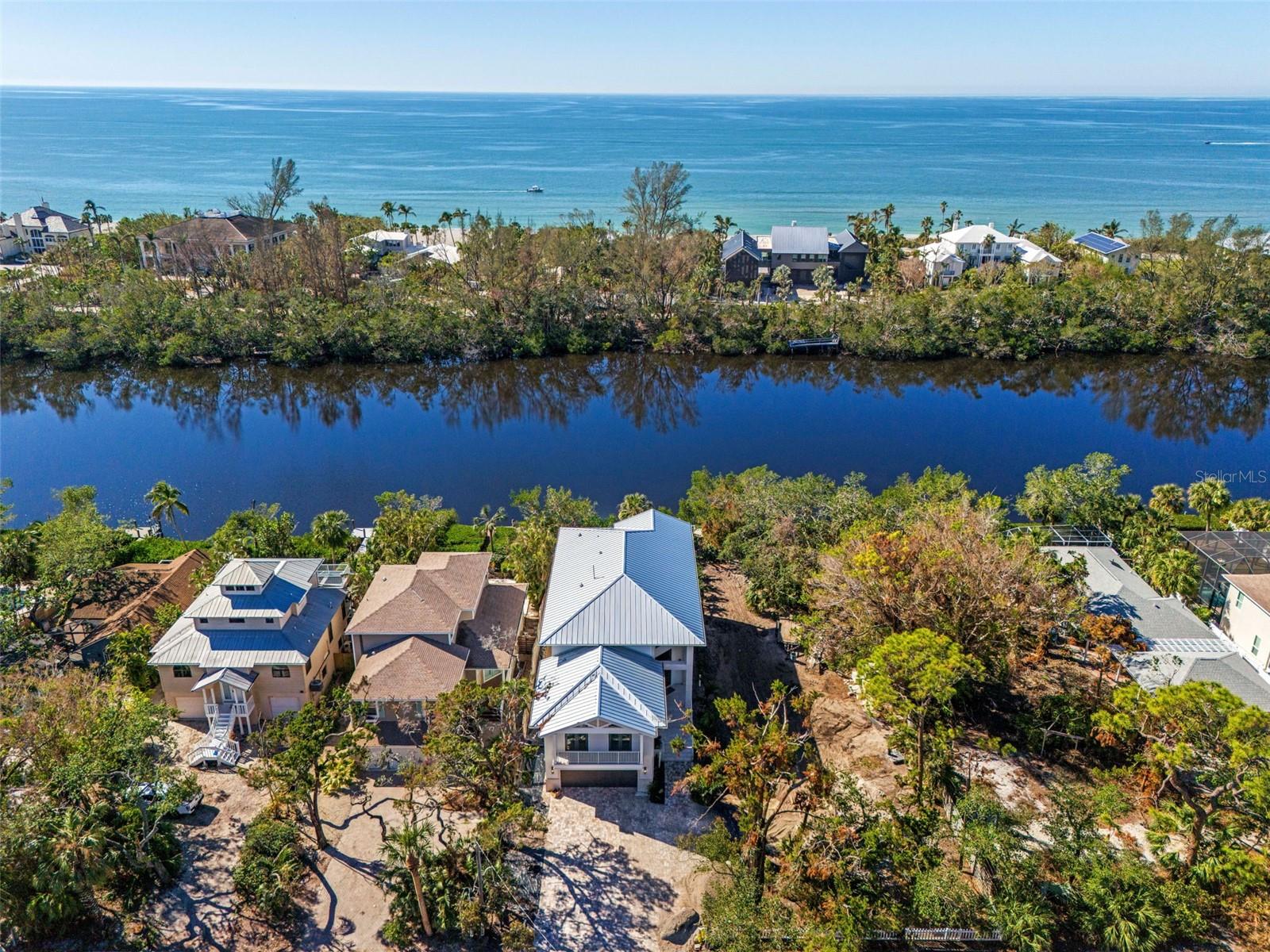 Major price reduction for immediate sale. Construction just completed on this new residence on the south end of Siesta Key. Located on Heron Lagoon offering breathtaking sunset views from various vantage points of the home’s major rooms. The best news: it’s totally FEMA compliant to the latest standards. High and dry from recent storms with NO water in the home and only a minor amount in garage. There is a sealant on perimeter from foundation to 1st level. The perfect solution for island lovers who want the protection of an elevated new home. The interior of this exceptional residence features an expansive and inviting atmosphere and its architectural charm is enhanced by trayed volume ceilings. The open and spacious Great Room and kitchen perfectly poised for entertaining. The kitchen is a culinary haven, featuring custom solid wood cabinets with painted shaker doors and quartz counters. State-of-the-art stainless steel appliances include a 6-burner gas range top with a griddle, a combination microwave/wall oven with dual fan convection, and a glass-door beverage refrigerator. The home boasts 7-1/2" wide European White Oak Hardwood plank flooring with a wire brush texture and polyurethane finish throughout,. The bathrooms showcase porcelain floor and wall tiles, custom solid wood cabinets, and either quartz or quartzite counters. The second floor of this residence features a splendid owner’s suite with a balcony, captivating water views, a luxurious master bath, a spacious loft, and three additional en-suite bedrooms. Pool-side is the expansive covered patio with pool bath, outdoor kitchen equipped with a natural gas grill creating the perfect setting for al fresco dining. Kick off your shoes and grab your paddle board or kayak and enjoy the afternoon on waters of Heron Lagoon from your private dock. Nestled in this peaceful locale, away from the hustle and bustle of daily life, the property remains conveniently close to the Stickney Point bridge, ensuring easy access on and off the island. Turtle Beach is a mere half-mile away, along with a marina for boaters. Easy to show.