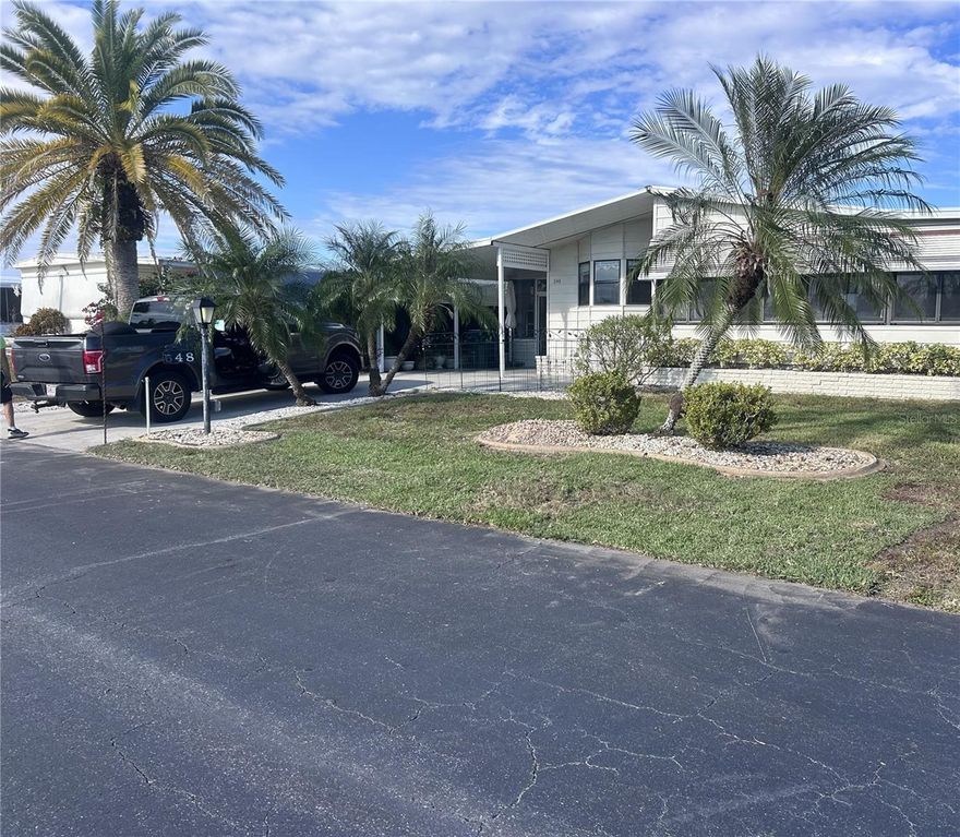 Welcome to La Casa where you will find affordable resort style living! This beautiful 2 bedroom 2 bath double wide home is located toward the back of the community with a pretty lake view from the front Florida room and the enclosed patio off the carport. The enclosed patio is a pleasant place to sit and enjoy nature. You will also find a generous size shed with washer/dryer. Once inside you'll find a fully equipped eat-in kitchen with bay window overlooking the lake. There is also a formal dining room with built-in hutch, skylight and ceramic tile floor. The large living room features lots of windows making it light and bright. There is a slider to the generous sized Florida room that overlooks the lake. There is a window a/c unit so you can spend hours watching the wildlife all year around. On the other side of the home you'll find the guest bedroom and bathroom. Both are good size. The guest bath features a tub/shower combination with grab bars already in place. The guest bedroom is adorably furnished and features a large closet that goes the whole length of the room. At the end of the home is the primary bedroom which is a great size and features an ensuite bath with 2 closets, one being a walk in. There's lots of built in drawers and cabinets in the vanity area, and the commode and shower area are separate. This home is being offered turnkey furnished, so all you have to do is move in, unpack and start enjoying the La Casa lifestyle. The amenities are 2nd to none with 2 heated pools, tennis courts, fitness room, billiard room, pottery room and so much more. The "Rec Center" is home to a ballroom type gathering room where so many activities take place. The "Clubhouse" is where you will find the billiard room, pottery room, library, card room and more. The Rec Center and Clubhouse both have heated pools. Did I mention the boat ramp to Gulf access water?  You can have all this for a very low monthly HOA fee, so don't wait, this affordably priced home can be yours.