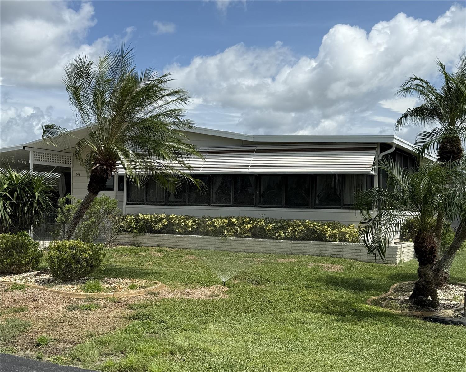 Welcome to La Casa where you will find affordable resort style living! This beautiful 2 bedroom 2 bath double wide home is located toward the back of the community with a pretty lake view from the front Florida room and the enclosed patio off the carport. The enclosed patio is a pleasant place to sit and enjoy nature. You will also find a generous size shed with washer/dryer. Once inside you'll find a fully equipped eat-in kitchen with bay window overlooking the lake. There is also a formal dining room with built-in hutch, skylight and ceramic tile floor. The large living room features lots of windows making it light and bright. There is a slider to the generous sized Florida room that overlooks the lake. There is a window a/c unit so you can spend hours watching the wildlife all year around. On the other side of the home you'll find the guest bedroom and bathroom. Both are good size. The guest bath features a tub/shower combination with grab bars already in place. The guest bedroom is adorably furnished and features a large closet that goes the whole length of the room. At the end of the home is the primary bedroom which is a great size and features an ensuite bath with 2 closets, one being a walk in. There's lots of built in drawers and cabinets in the vanity area, and the commode and shower area are separate. This home is being offered turnkey furnished, so all you have to do is move in, unpack and start enjoying the La Casa lifestyle. The amenities are 2nd to none with 2 heated pools, tennis courts, fitness room, billiard room, pottery room and so much more. The "Rec Center" is home to a ballroom type gathering room where so many activities take place. The "Clubhouse" is where you will find the billiard room, pottery room, library, card room and more. The Rec Center and Clubhouse both have heated pools. Did I mention the boat ramp to Gulf access water? You can have all this for a very low monthly HOA fee, so don't wait, this affordably priced home can be yours.