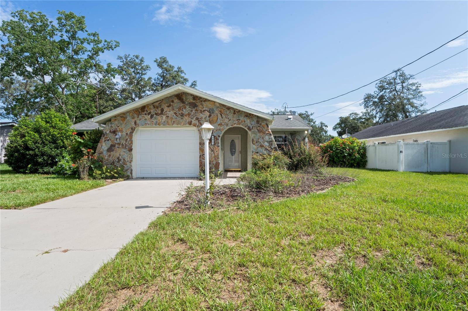 A Diamond in the Rough - Embrace Florida Living! Discover the potential of this fantastic pool home, offering the best of the Florida lifestyle. Featuring 2 bedrooms, 2 bathrooms, and a 1-car garage, this home is designed for comfort and outdoor enjoyment. The kitchen, dining, and living areas are tiled throughout, with the kitchen offering ample cabinet space. The spacious living with fireplace and dining rooms open to the screened lanai through sliding glass doors, perfect for seamless indoor-outdoor living. The primary bedroom features two closets, a private en-suite bath, and its own sliding doors leading to the lanai. Step outside to a generously sized covered lanai and screened pool area (birdcage enclosure) ideal for entertaining or relaxing. The backyard is fully fenced and includes a shed for extra storage. Major updates include a new roof and AC system in 2014 information from county permitting. Bring your personal touches and make this home your own private Florida retreat!