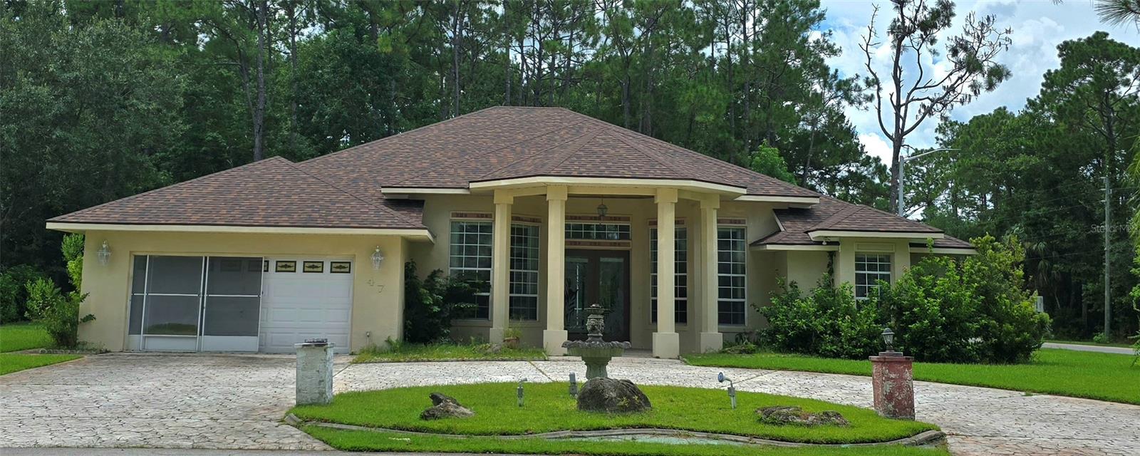 This light filled concrete block stucco built home has so much potential. BRAND NEW ROOF 2025; HOT WATER TANK 2017; horseshoe shaped concrete stamped driveway, 2 car garage, split bedrooms with a huge primary suite that overlooks the pool. The spacious kitchen includes a dining nook with mitered windows overlooking the pool and is open to the family room. The family room offers a gas fireplace and three stackable sliding doors to make entertaining inside and outside seamless. The dining room is located off of the kitchen in the front of the home and has plenty of room for a formal dining set. The formal living area opposite the dining room would make a lovely sitting area or even a great office space. The inground pool is 1087 square feet with a small fountain area and a spa, with a brand new pump. There is ample shaded area under roof and a screened enclosure around the pool. There is a full bath accessible from the lanai and perfectly located for the other 2 bedrooms or guest use. There is a walk in shelved pantry with pocket door right off the kitchen for your extra appliances and sundries. Next to the pool bathroom is a ventilated storage closetfor pool supplies or toys! Beyond the pool is a thickly wooded area ensuring privacy while swimming and relaxing out back.The primary suite has double trey ceilings, a huge walk in closet, plus an oversized linen closet near the private water closet. The jetted tub, dual vanities, and walk in shower complete your dream primary retreat.Conveniently located off the kitchen is an indoor laundry room complete with deep sink and cabinets for storage. 6 miles from Flagler beach & less than a mile from the town center shopping area with a Publix and dining options and right across the street from the Cypress Knoll Golf and Country Club. Quick trip to Target and other shopping and dining options. Minutes to 95