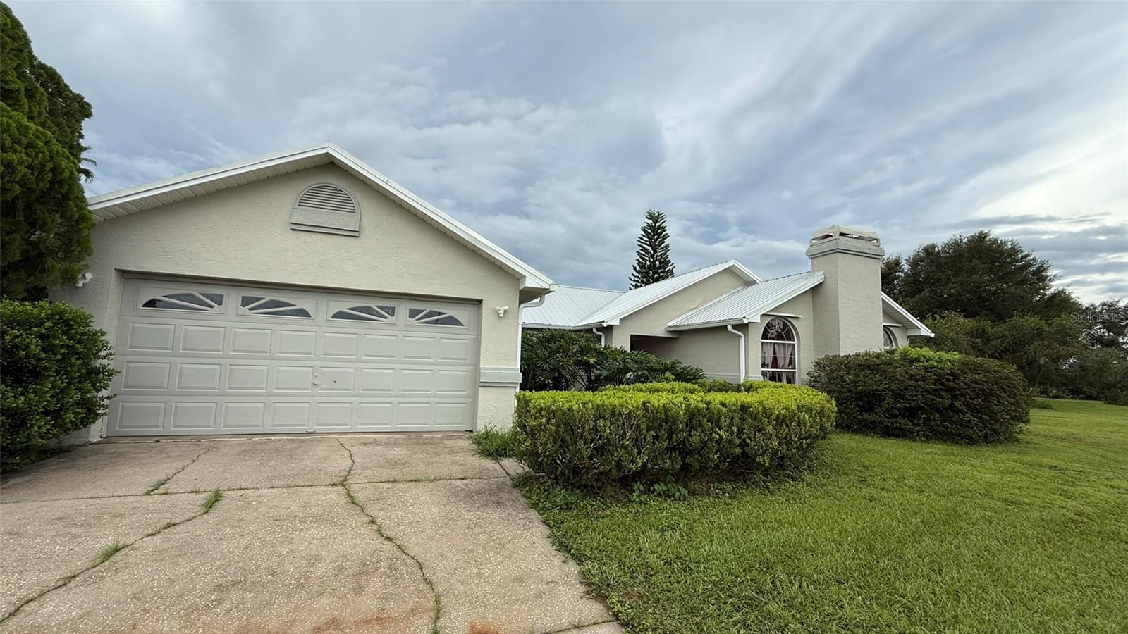 Location! This beautiful 3 bedroom, 2 bathroom home has a spectacular five acre corner lot overlooking the rolling hills between Dade City and Zephyrhills. Situated facing to the Northwest, imagine enjoying the unobstructed beautiful Florida sunsets from your expansive yard and your forever home. Entering the home through its double doors you are greeted by the large kitchen, and to your right the living room with it's stone fireplace. As well as ample interior living space, this home has an enormous 21 foot by 12 foot air conditioned Florida Room. This home also has an incredible 2,400 sq. ft. garage / workshop with an attached carport for your motorhome or boat. Come and enjoy the tranquility in this amazing property.