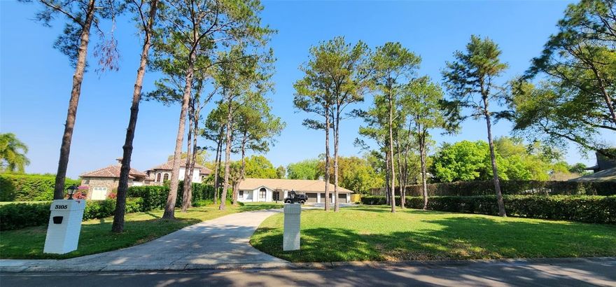 Welcome to The Manors at White Trout Lake. Experience luxury, privacy, and timeless comfort in one of Tampa Bay’s most prestigious gated enclaves—The Manors at White Trout Lake. Tucked behind a private tree-lined gate with only ten exclusive residences, this meticulously remodeled single-story 5-bedroom, 3-bath, 3-car garage estate with pool and bonus space sits gracefully on nearly one acre of pristine land. From the moment you arrive, the impressive curb appeal and manicured grounds create an undeniable sense of grandeur. Inside, over 4,000 square feet of open, light-filled living space showcase soaring ceilings, elegant new flooring, designer mid-century lighting, and modern architectural finishes that complement a luxurious, easy-flowing layout. At the heart of the home, the chef-inspired kitchen is a masterpiece—anchored by stunning walnut cabinetry, granite countertops, GE Profile stainless steel appliances, and a spacious eat-in design with a convenient pass-through bar to the family room. The adjacent pantry corridor adds incredible storage and functionality, complete with a second refrigerator for everyday convenience. The expansive family room invites gathering and relaxation around a cozy wood-burning fireplace, while the oversized bonus/media/office space offers flexible options for work, fitness, or entertainment. The primary suite is a true sanctuary, featuring a resort-style spa bath with whirlpool tub, walk-in closet, and serene garden views. A connecting bedroom offers ideal space for a nursery, private office, or dream dressing retreat. A separate bedroom wing can easily serve as a comfortable in-law or guest suite, offering privacy and style with beautifully renovated bathrooms and thoughtful design. Step outside to your own private resort—a covered lanai with a full outdoor kitchen, a screened pool with a new cleaning system, and a sprawling fenced yard ideal for children’s play, sports, or tranquil outdoor living. The regulation-height basketball hoop and vast lawn make it perfect for family fun or entertaining on a grand scale. This exceptional estate also features a newly painted exterior, refreshed landscaping, a redesigned laundry room, abundant storage, and recent roof and A/C replacements (2020) ensuring peace of mind for years to come. Additional upgrades include rain gutters, a Kinetico water softener, and a reverse osmosis system. Residents of The Manors at White Trout Lake enjoy gated privacy, mature natural beauty, and the tranquility of a luxury lifestyle, nestled near the sparkling 78-acre White Trout Lake in the Sweetwater Creek Watershed. Though this property offers no direct lake access, its sense of serenity and seclusion rivals any waterfront retreat.  Monthly services include professional landscaping, lawn irrigation, pool care, and pest control—ensuring your time is spent enjoying the best of luxury living. This is more than a home—it’s a rare sanctuary in one of Tampa Bay’s most sought-after communities. Schedule your private showing today and experience why The Manors at White Trout Lake is truly a must-see hidden gem of elegant Florida living. Thank you
