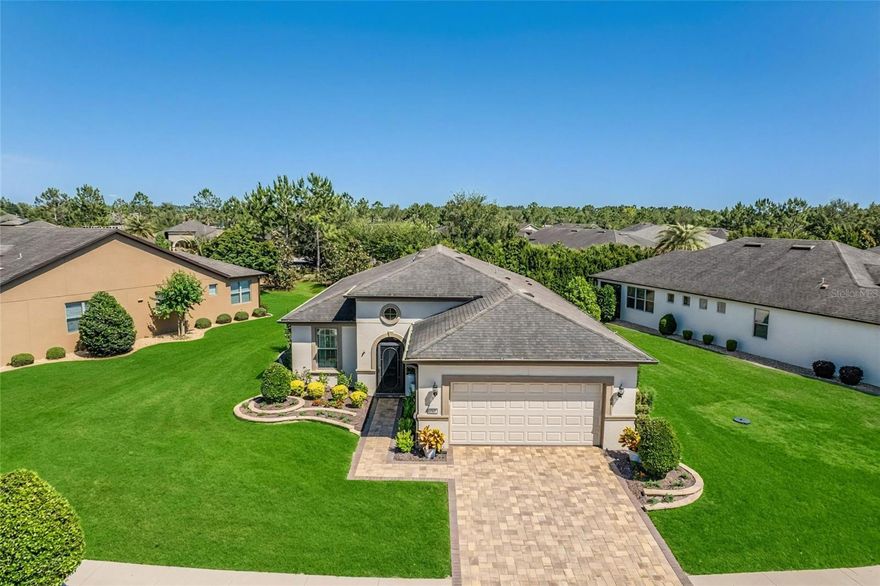 Discover the perfect blend of elegance and function in this highly sought-after Castle Rock floor plan in Stone Creek. From the moment you arrive, the decorative raised garden beds and paver driveway create a warm, inviting welcome. Inside, the home feels brand new, featuring soaring ceilings and seamless tile and laminate flooring throughout. The chef-inspired kitchen offers expansive counter space and abundant cabinetry, making it a dream for any culinary enthusiast. In the great room, custom plantation shutters frame a serene, private view of lush greenery, ensuring your living space feels like a secluded retreat.

This property stands out with significant structural upgrades that provide the extra room you need. The garage was professionally extended by 4 feet, creating an oversized space perfect for larger vehicles, a golf cart, or a dedicated workshop. For those who love the Florida lifestyle, the lanai was also extended an additional 10 feet, resulting in a massive and comfortable outdoor sitting area overlooking the private backyard. The primary suite serves as a sophisticated escape, complete with a tray ceiling, an expansive walk-in closet, and a large solid-surface vanity with dual sinks.

To provide complete peace of mind, this home also comes with a one-year home warranty included. If you are looking for a move-in-ready home that offers privacy, security, and thoughtful upgrades at every turn, this is a must-see. Schedule your tour today, and tomorrow you may be calling it home.