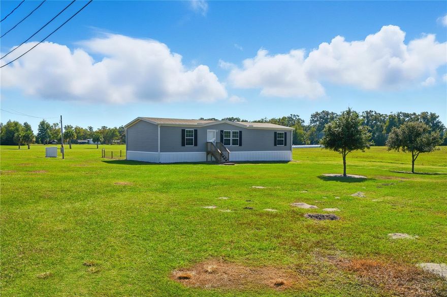 Escape to peaceful country living with this beautiful 2024 manufactured home situated on 5 serene acres in Trenton, FL. This 3-bedroom, 2-bath home offers modern comfort and plenty of room to enjoy the outdoors. Inside, you’ll find an open floor plan with a spacious living area, stylish finishes, and a bright, welcoming kitchen perfect for family gatherings or entertaining guests. The primary suite features a private bath for added convenience. Outside, a small fenced-in area behind the home is ideal for pets or a garden space, while the rest of the property provides endless opportunities for recreation, expansion, or simply soaking in the quiet rural setting. Located just a short drive from town amenities and the Suwannee River, this property combines modern living with the charm of country life