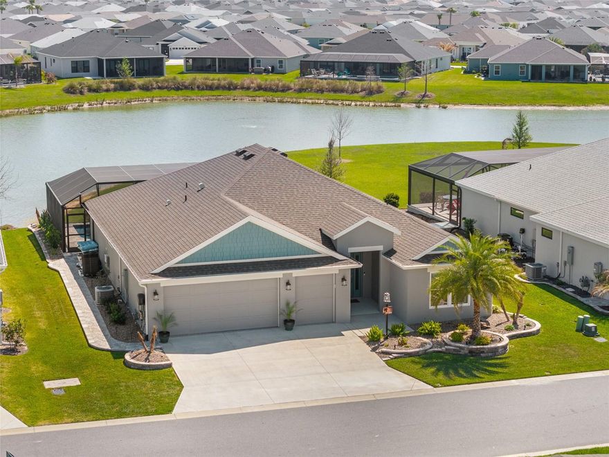 Step into elevated Florida living with this beautifully upgraded 2024-built 3-bedroom, 2-bath BLOCK & STUCCO, MOCKINGBIRD floorplan offering 1,959 sq ft of thoughtfully designed living space in the Village of Moultrie Creek in The Villages. Perfectly positioned with a serene WATER VIEW and just minutes from the highly anticipated EASTPORT TOWN CENTER, this home delivers an exceptional combination of space, style, and location.
From the moment you arrive, the ELEVATED, STONE-CURBED LANDSCAPING surrounding the home creates a polished and inviting first impression. The expanded driveway leads to a highly desirable 2-CAR GARAGE PLUS GOLF CART GARAGE, providing ample space for all vehicles and the signature Villages lifestyle. Inside, the SPLIT OPEN FLOORPLAN is designed for both everyday living and entertaining, featuring VAULTED CEILINGS, abundant natural light, and LUXURY VINYL FLOORING THROUGHOUT for a clean, modern, and low-maintenance finish.
The kitchen serves as the heart of the home, showcasing QUARTZ COUNTERTOPS, CROWNED UPGRADED CABINETRY, TILE BACKSPLASH, PENDANT LIGHTING, and STAINLESS STEEL APPLIANCES, including a GAS STOVE with a built-in AIR FRYER and a FARMHOUSE SINK. The seamless flow into the dining and living areas makes it ideal for both hosting and daily comfort. The primary suite offers a private retreat with a TRAY CEILING, abundant natural light, and HIS AND HERS CUSTOM CLOSETS. The en suite bathroom features DUAL SINKS, FRAMED MIRRORS, WHITE CABINETRY, and a WALK-IN TILE SHOWER with A BUILT-IN BENCH.
Guest accommodations are thoughtfully positioned for privacy, with one guest bedroom featuring a TRAY CEILING and the other offering a VAULTED CEILING, and both including closets. The guest bathroom continues the upgraded finishes with QUARTZ COUNTERS, a FRAMED MIRROR, and a TUB AND SHOWER COMBINATION WITH TILE. SLIDING GLASS DOORS open to a HUGE GLASS-ENCLOSED FLORIDA ROOM with EPOXY FLOORING, PRIVACY SHADES,  and LARGE CEILING FANS. Followed by a RESORT-STYLE IN-GROUND POOL under a BIRDCAGE ENCLOSURE with ELECTRIC PRIVACY SCREENS, a PAVER POOL DECK, and an OUTDOOR SUMMER KITCHEN that is perfect for entertaining. Additional highlights include an INSIDE LAUNDRY ROOM with BUILT-IN CABINETS and a UTILITY SINK for added convenience and storage.
Location is a true standout, with close proximity to GOLF COURSES, RECREATION CENTERS, SHOPPING, DINING, and NIGHTLY ENTERTAINMENT, as well as the upcoming EASTPORT MEGA CENTER and TOWN SQUARES. Furniture is available as a separate purchase!