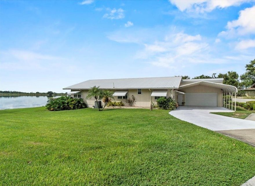 True Lakefront Living in Central Florida

Discover affordable luxury with this rare true lakefront home offering stunning water views and endless amenities. Featuring 3 bedrooms, 2.5 baths, and soaring ceilings reaching nearly 15 feet, this home is designed for both comfort and style.

Built with steel and metal construction for lasting durability, the home includes hurricane shutters, plantation shutters, and abundant cabinetry throughout. The primary suite is a retreat of its own with a walk-in spa tub, separate shower, and even a private sauna.
Enjoy lakeside relaxation from the back lanai with built-in spa, overlooking a beautifully landscaped yard that stretches right down to the water’s edge with full irrigation.

The oversized double garage with natural light is perfect for hobbies or workshop space, while the additional double carport provides extra covered parking.

Located in the charming town of Lake Alfred, this property offers a peaceful lakefront lifestyle with easy access to I-4, putting you just a short drive from both Orlando and Tampa.