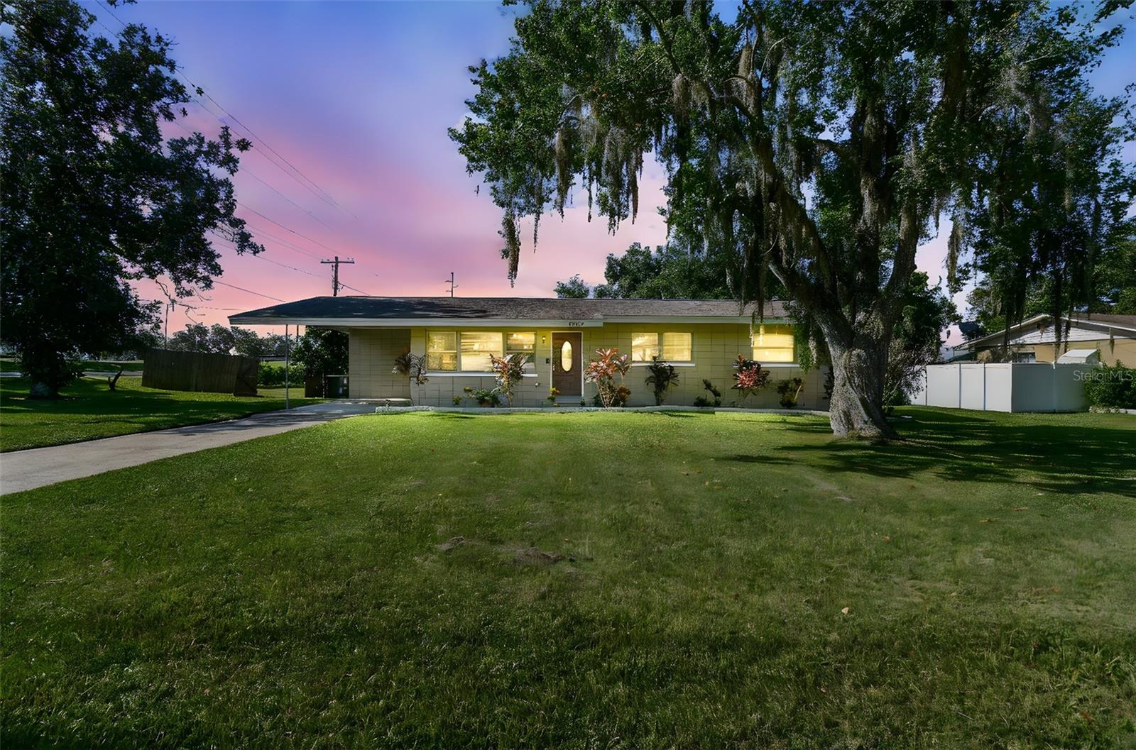 MID-CENTURY MODERN GEM WITH CONTEMPORARY COMFORTS! This MID-CENTURY MODERN has curb appeal and character to its core! From the extra large 0.37 AC CORNER LOT to the HORIZONTAL STACK masonry pattern that it was originally constructed with, this home is pretty special. The interior of this ranch home was recently remodeled in 2020, so it has a beautiful blend of historic charm and contemporary comforts. With 4 BEDROOMS and 2 FULL BATHROOMS, you will have room to grow here and plenty of space inside and out to host or entertain. The kitchen has been nicely updated with GRANITE counters, stainless steel appliances, and a neutral, multi-shaded subway TILE BACKSPLASH. The primary suite is set apart from the other bedrooms and it includes a WALK-IN CLOSET and a full bathroom with a classic aesthetic, including a pedestal sink. All of the guest bedrooms are clustered in the same wing of the home. The dedicated guest bathroom has been updated with newer fixtures and tile surrounding the SHOWER/TUB combo, but the built-in shelves and the WAINSCOTING deliver the nostalgia. The den/family room is ample space for gathering to read, watch a movie, or play video games in the day-to-day, but the crown jewel of the home is the 15x32 living room that proudly hosts a grand and elegant FIREPLACE with a stunning SOLID WOOD MANTEL that is perfect for decorating during the holiday season. This spot will surely become the built-in photo booth when hosting or entertaining. The huge living room leads out to the SCREEN ENCLOSED PATIO that overlooks the backyard. The yard is lined with shrubs that create a NATURAL FENCE for some privacy. There is a storage shed in the backyard to house your mower and gardening equipment. There are some lovely flower beds that trim the front of the home and part of the backyard, as well. This remarkable home is conveniently located in the heart of Dade City just walking distance to some of Dade City’s best parks, schools, and historic Church Avenue which is where Dade City’s premier holiday event Church Street Christmas takes place each year. If you want a WALKABLE, small town lifestyle this home is a passageway to all that you dream of and it can be yours. Call to schedule your personal tour today!