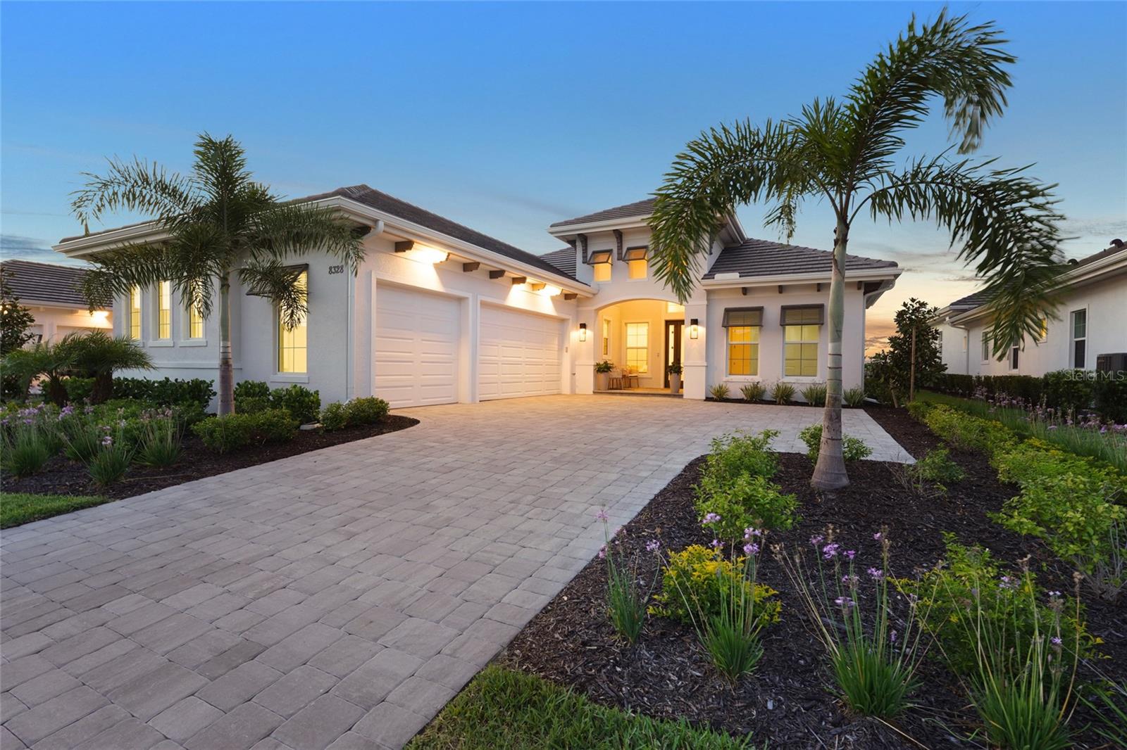 ONLY $560/SQFT! UNBEATABLE PRICE. Welcome to your dream home in Wild Blue at Waterside! Wild Blue is Lakewood Ranch's hottest new neighborhood and this is a great opportunity to get into the community at an unbeatable price! The community will include a resort style clubhouse with 25,000 sq. ft. of indoor/outdoor space and an on-site lifestyle director. Amenities will include a fitness studio with work out classes, golf simulator and putting green, dining both indoors and out and a theatre. In addition, Wild Blue residents will have access to the shared hub at Midway Sports Complex which includes tennis & pickleball courts, basketball, kayak launch, walking trails, dog parks, a playground and pavilions. Conveniently located near Waterside shopping and dining, UTC, Lakewood Ranch Main Street, and just a short drive to Sarasota Airport and the renowned beaches along the gulf coast. Why wait to build?! This newly completed, never-lived-in Mayfield III model by Stock Luxury Homes offers modern luxuries throughout and embodies the perfect combination of style, comfort, and premier location. Situated on a 64' lot, with an expansive outdoor area and over 3,000 sq ft of living space, which includes 4 bedrooms, 3.5 bathrooms, formal dining, and a study. The home greets you with exquisite landscaping, and exceptional curb appeal with bahama shutters and a sleek glass entry door. Thoughtfully curated, this open concept floor plan features soaring ceilings, designer lighting and fans, and tile flooring that flows seamlessly throughout. The kitchen is well-appointed with soft close custom cabinetry, quartz countertops, beautiful tile backsplash, a large island, and high-end KitchenAid appliances. The great room is complimented by a dry bar and pocket sliding doors to the lanai, making this home perfect for entertaining. The owners suite is equipped with an on-suite that includes dual vanities, a luxurious shower and soaking tub, and a private water closet. Two large walk-in closets are ready to be customized into the closet of your dreams. The owners retreat also offers private lanai access with french doors. Step outside to your backyard oasis, featuring an expansive lanai, a state-of-the-art outdoor kitchen, and a clear-view pool screen that frames tranquil water views. Relax in the saltwater pool and spa, designed to provide a true sense of paradise. This luxurious home offers the ultimate Florida lifestyle, blending sophisticated design, stunning surroundings, and the unmatched quality of Stock Luxury Homes. PGT impact resistant windows and sliding doors and a 3-car garage with epoxy flooring will check all the boxes for the man of the house. Don't miss the opportunity to make this one yours!