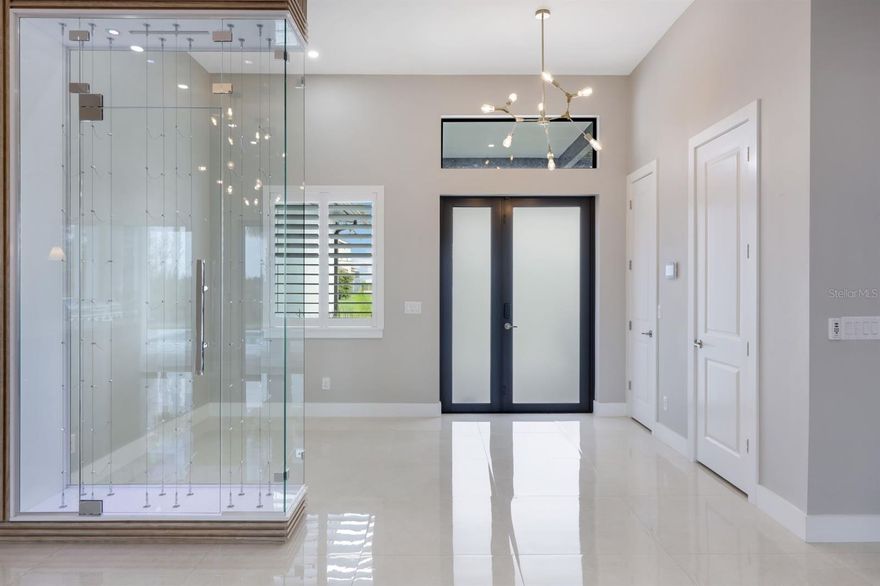 Southern Exposure, Newer Built Salt Water Pool Home! ASSUMABLE VA MORTGAGE AT 5.75% - Available to Veterans! Welcome to this stunning modern home in the up and coming and highly sought-after Pine Island Corridor. This exquisite residence features 3 spacious bedrooms and 2.5 well-appointed bathrooms, offering floating cabinets, quartz counters and high end fixtures. Pull into the oversized concrete driveway with a decorative transition, leading to a 3-car epoxy floor garage, plus additional parking pad. Inside, the home is designed with sophisticated touches such as straight stacked porcelain tile throughout, impressive 12 ft ceilings, and elegant brass Sputnik chandeliers, impact windows and doors throughout. The open space kitchen is a chef's dream, featuring a 12 ft quartz countertop island and backsplash, European-style cabinets with soft-close technology, 2 Whirlpool stainless steel ovens and a commercial grade hood vent. The living area includes a wine case feature wall with an art niche and an electric fireplace, creating a cozy and stylish atmosphere. One way solar tinted sliding glass doors lead to the oversized pool area, perfect for outdoor entertaining ensuring privacy as well as energy efficiency. Cool off in the electric heated crystal blue blue salt water pool with sun shelf surrounded by a fenced-in backyard beautifully landscaped with an assortment of pygmy dates and palm trees. Additional outdoor amenities include oversized pavered sun pad, outdoor shower and a summer kitchen with a grill, refrigerator, and sink. Smart home features such as a Google entry, security system, along with LED lighting throughout, add to the modern conveniences of this home. Contemporary touches such as a decorative wine display, plantation shutters, remote controlled custom zebra blinds, built in custom closets and floating cabinets make this home is a perfect retreat for those who appreciate modern luxury and enjoy the Florida lifestyle. Head down to the Pine Island Corridor for a plethora of dining, shopping and entertainment options. City Water and Sewer in Place! You deserve to enjoy everything SWFL has to offer - beautiful weather year-round, world class fishing, golfing, kayaking, paddle boarding, tubing, jet ski or just relax in your very own tropical paradise! Call and schedule a private viewing today! NOT located in an HOA!