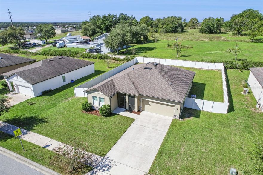 Welcome to your move-in ready dream home in Groveland!  This beautifully maintained 3-bedroom, 2-bath single-story home offers the perfect blend of comfort, style, and functionality. Featuring a spacious open floorplan, luxury vinyl flooring throughout, and an abundance of natural light, this home is designed for both relaxed living and effortless entertaining.

Step into a bright and airy living space where the kitchen seamlessly overlooks the family and dining rooms—ideal for hosting gatherings or staying connected with loved ones. The fully equipped kitchen boasts granite countertops, stainless steel appliances, a large center island with seating, and a closet pantry for extra storage.  Enjoy Florida living at its best with both a screened front porch and a rear lanai, perfect for morning coffee or evening relaxation. The large, fully fenced backyard offers ample space for pets, play, or future outdoor projects. The spacious primary bedroom features an en-suite bath with a generous walk-in closet, offering a peaceful retreat at the end of the day.

Located in the fast-growing city of Groveland, this like-new home combines the charm of a rural, small-town setting with the convenience of nearby lakes, rolling hills, nature trails, and greenspace. You’ll enjoy a quiet, laid-back lifestyle just a short drive from shopping, dining, and everything Florida is known for.  Don’t miss the opportunity to own a bright, beautiful home that feels brand new—located in one of Lake County’s most desirable and fast-growing communities!