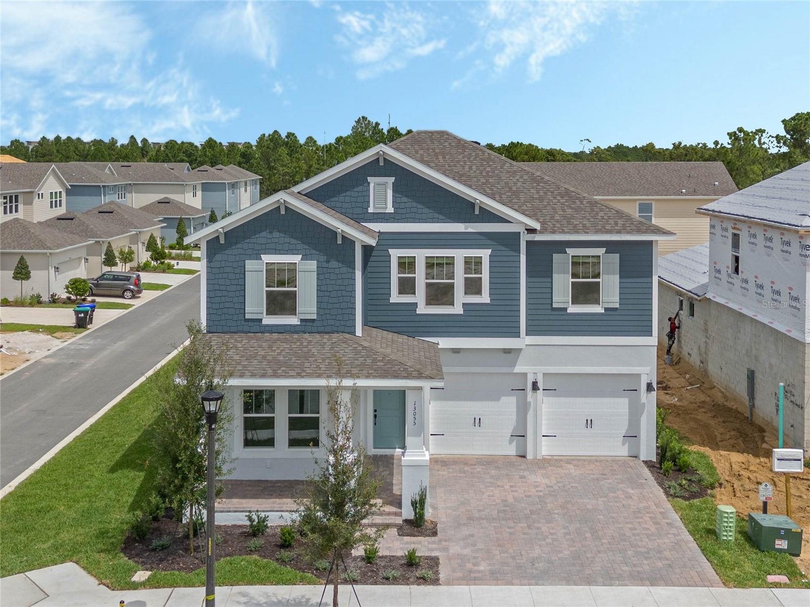 Under Construction. Luxury New Home by RockWell Homes. Experience the ultimate in modern luxury with this stunning new home on oversize home site with room for a pool (lot#130). This spacious 5 bedroom, 4-bathroom design offers the perfect combination of style, functionality, and comfort. The home features a 3-car garage and both a covered front porch and a covered backyard lanai, ideal for outdoor relaxation or entertaining. The heart of the home is the chef-inspired kitchen, which includes solid surface countertops, an island, and high-end stainless steel gas appliances, such as a cooktop, oven, microwave, and dishwasher. The kitchen also features an undermount sink with a Delta faucet, a beautiful ceramic tile backsplash, upgraded 42-inch cabinets, upgraded flooring, Delta faucet and a huge walk-in pantry, providing ample storage and making it a dream space for any home chef. The spacious living area is designed with upgraded flooring and enhanced with natural light flowing in through dual-pane energy-efficient windows. These windows offer access to the covered backyard lanai, seamlessly blending indoor and outdoor living spaces. The private primary suite is a true retreat, featuring dual sink vanities with Delta faucets, ceramic tile flooring, and a luxurious oversized shower with a glass enclosure. Additional features include a lighting package, towel bars, and a huge walk-in closet, offering plenty of storage and comfort. The secondary bedrooms are generously sized, each with its own walk-in closet and access to separate bathrooms. These bathrooms include ceramic tile flooring, ceramic tile tub/shower surrounds, Delta faucets, lighting packages, and towel bars, ensuring both style and functionality. Additional features of this exceptional new home include a full sprinkler system, a complete landscaping package, energy-efficient construction, a garage door opener, and a utility area with ceramic tile flooring. The home also boasts an 8-foot front door, a private backyard for added privacy, and a new home warranty for peace of mind. This luxury new home by RockWell Homes offers a perfect combination of upscale living, energy efficiency, and a beautifully designed layout. It’s ideal for those looking for both style and comfort in their next home. Quick access to Walt Disney World Theme Parks, downtown Orlando, shopping, dining and Winter Garden.