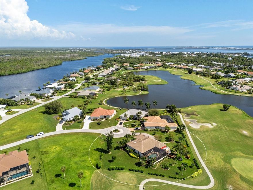 An extraordinary opportunity awaits in one of Placida’s most sought-after neighborhoods. Nestled at the end of a quiet, secluded cul-de-sac, this elegant residence is thoughtfully situated across two expansive parcels, surrounded by the lush fairways of The Links Golf Course and scenic waterways that define coastal Southwest Florida living.  Enjoy panoramic views of winding lakes that gracefully wrap around the home, along with picturesque vistas of the Coral Creek waterway just across the street. The park-like grounds are a true sanctuary, featuring manicured gardens, a tranquil koi pond with waterfall, fruit trees, and lush tropical foliage — all designed for peaceful living in harmony with nature.  Step inside to discover a warm and welcoming interior with wood and ceramic tile flooring throughout, soaring vaulted ceilings, and abundant natural light. Both the living and family rooms offer captivating views, creating the perfect setting for relaxation or entertaining. The home has been meticulously maintained and thoughtfully updated, with premium enhancements that include a new roof in 2020, new impact-resistant windows and doors, storm-rated garage door, and a new AC system in 2021.  The chef’s kitchen, fully remodeled in 2016, features light wood cabinetry, stone countertops, and top-tier appliances, opening seamlessly into the family room and out toward breathtaking views.  In 2023, the lanai received a stunning upgrade with a new "open view" pool cage, maximizing visibility of the surrounding landscape. The heated saltwater pool is the ideal place to unwind and enjoy Florida’s year-round sunshine.  Located in Cape Haze Windward, a premier Placida community known for its charming golf course, winding streets, generous greenbelts, and proximity to nature preserves, waterways, and parks. You'll be walking distance to Publix, local restaurants, and shops, and just minutes from historic Boca Grande, world-class fishing, boating, multiple marinas, and renowned golf courses.