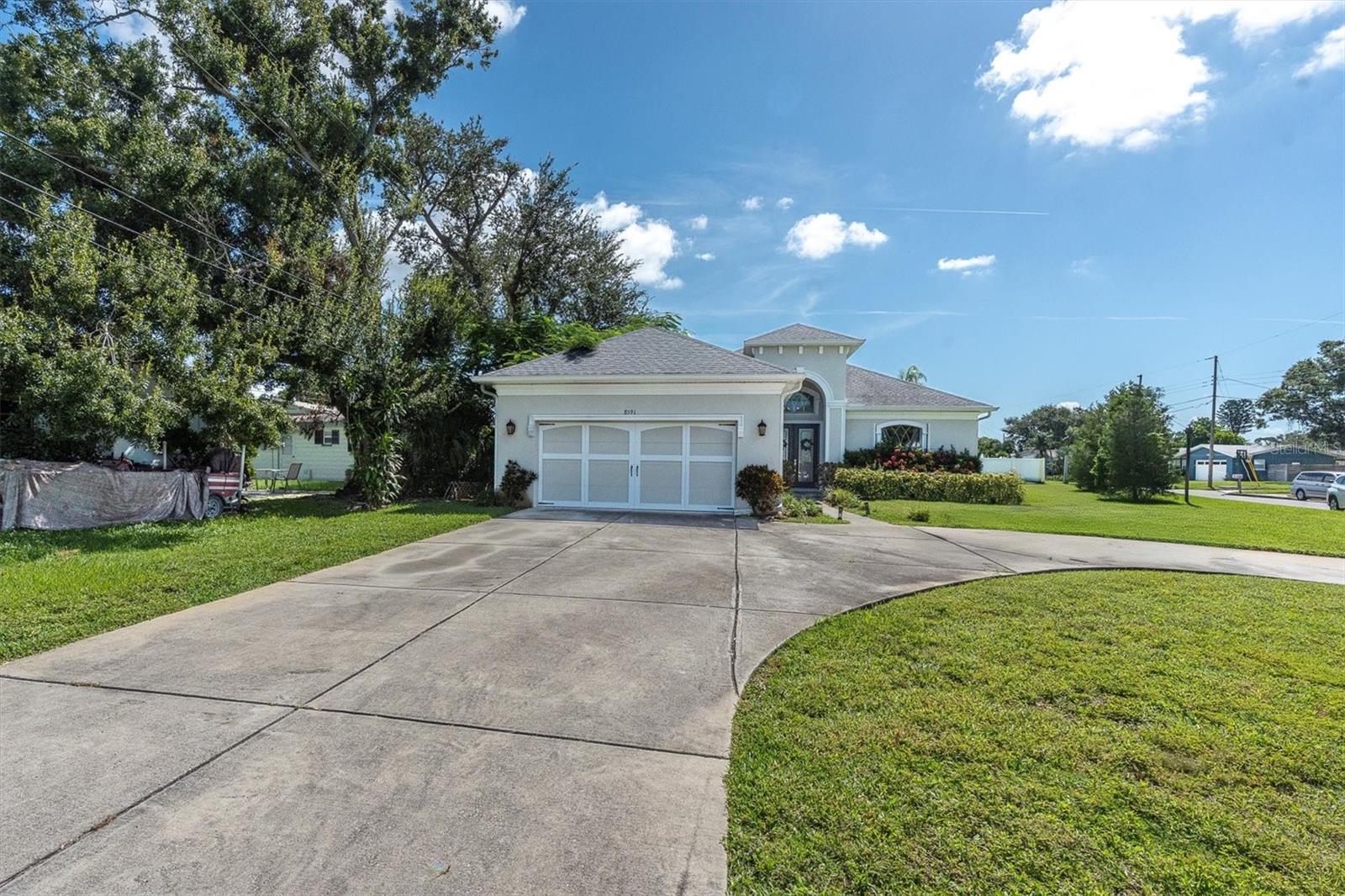 Beautiful newer construction 3/2 ½ bath home with an oversized 2 car garage in a highly desirable location in Seminole. High and dry here with no flooding in the area from the storms. Almost a ¼ acre lot with expansive parking and room for a pool. There is a stunning 22 foot entryway with a beautiful restoration hardware chandelier right when you enter the home. Great open floor plan with split bedrooms. There is a very large 15 x 14 separate formal dining room off of the entry way. Spacious and gorgeous open kitchen and massive living room area. Beautiful engineered hardwood flooring throughout the living areas. The kitchen has beautiful granite countertops, and ample amount of custom cabinets, a double sink, and a large walk-in pantry with tons of room for storage. Very open with a sizable cozy breakfast nook area with natural light from the windows. You will love the massive master suite with a very spacious bathroom with double sinks, an oversized separate soaking tub, and a separate water closet. The master bedroom boasts 2 walk-in closets with plenty of room for a king-size bed and additional furniture pieces. High vaulted ceilings throughout the living areas and primary bedroom with 14-16 foot high panned ceilings along with dual level crown molding throughout the living area and primary bedroom. High end craftsmanship throughout the home with a beautiful hand crafted column entry way into the formal dining room also with a beautiful restoration hardware chandelier. You can’t find a remodeled or updated home with features and vaulted ceilings like this. Covered outdoor patio area and layout makes a great entertaining home for friends and family. The oversized 2 car garage has a built-in ½ bath with additional built-in storage and an easily accessible walk-in attic with pull down stairs. Hurricane shutters that are easy to pop in all of the exterior are stored in the garage. Built in 2017 by the prestigious Deeb Family Homes and is under builder structural warranty through 2027. Insurance is a fraction of the cost with a newer build compared to a remodeled home. Perfect location with walking distance to all of the reputable Seminole schools. Just minutes to the beaches and a few of the best parks in the county- Walsingham, Lake Seminole, and Boca Ciega Millennium Park. Truly a perfect location with no flood insurance.