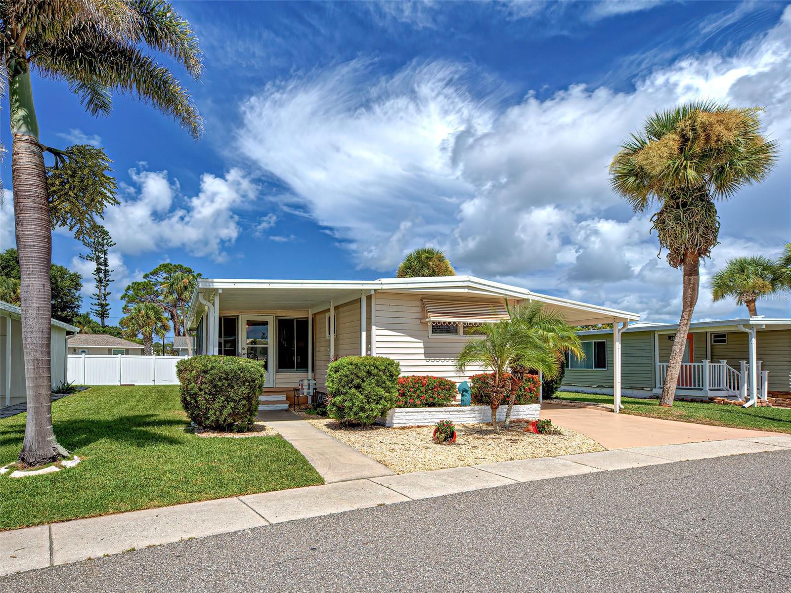 SWEET COASTAL COTTAGE - ADORABLE & AFFORDABLE – this 2 BEDROOM 1.5 BATH home is JUST UNDER 2 MILES TO MANASOTA KEY BEACH with its WHITE SANDY BEACHES & SPARKLING AQUAMARINE WATERS! Ideally located within the community, this home is CLOSE TO THE CLUBHOUSE with all the wonderful amenities Japanese Gardens has to offer! Whether you’re looking for a permanent residence or a “winter retreat”, this home fits the bill! The carport, with a storage shed, has room to tandem park up to 2 cars or perhaps a car and a golf cart. Residents of Japanese Gardens do enjoy tooling around the community in their golf carts! Upon entering, NEAT, CLEAN & PRISTINE are the words that best describe how well this home presents. With just the right amount of space, this home “lives large” with sliding glass doors that pocket & open all the way to the beautiful, natural light-filled all-weather Florida Room. Speaking of the Florida Room, a covered front porch welcomes your guests into the enclosed 10’ x 20’ Florida Room. This all-weather room expands your living space with a separate wall-unit for cooling during warmer months or just opening it up during the cooler winter months for year-round enjoyment. Be sure to read through the recent improvements below, which include a beautifully updated kitchen, primary bathroom with an inside stackable washer & dryer. CHECK OUT ALL THAT IS NEW – NOTHING LEFT FOR YOU TO DO – the recent updates to this home include PRIMARY BATHROOM UPDATED WITH NEW GE LARGE STACKABLE WASHER/DRYER (2022) • NEW ELECTRIC PANEL & MAIN BREAKER IN METER PEDESTAL, OUTLETS & SWITCHES REPLACED (2022) • NEW CEILING LIGHTS & PADDLE FAN (2022) • ELECTRICAL POWER TO SHED (2022) • NEW 40 GALLON WATER HEATER (2022) • WINDOWS REPLACED (2022) • NEW WINDOW TREATMENTS (2022) • NEW HVAC UNIT & DUCT WORK (2022) • NEW ROOF WITH ADDITIONAL INSULATION (2023) • NEW CARPORT MEETING BUILDING CODE (2023) • NEW KITCHEN FACELIFT INCLUDING NEW SINK FAUCET & DRINKING WATER FAUCET WITH 2 STAGE FILTER, TILE BACKSPLASH, ISLAND WITH SEATING, NEW REFRIGERATOR & EXHAUST HOOD (2023). You’re going to love living in Japanese Gardens, arguably one of the best and well-run parks in South Venice. A 55+ community with wonderful amenities and lots of activities including a heated pool with a lap lane, hot tub, pickleball, horseshoes, poker, bocce ball, billiards, a library, a meeting room, and social activities galore! The convenient location is near the Lemon Bay Preserve, the Venetian Trail, Shamrock Park, the South Venice Private Beach & Ferry, Multiple Public Beaches and more! Home is being sold partially furnished. Ask your agent for a list of excluded furnishings. DON’T MISS YOUR OPPORTUNITY TO AFFORDABLY OWN A HOME WHERE YOU CAN WALK, BIKE OR RIDE TO THE WHITE SANDY BEACHES OF THE GULF JUST MINUTES AWAY!