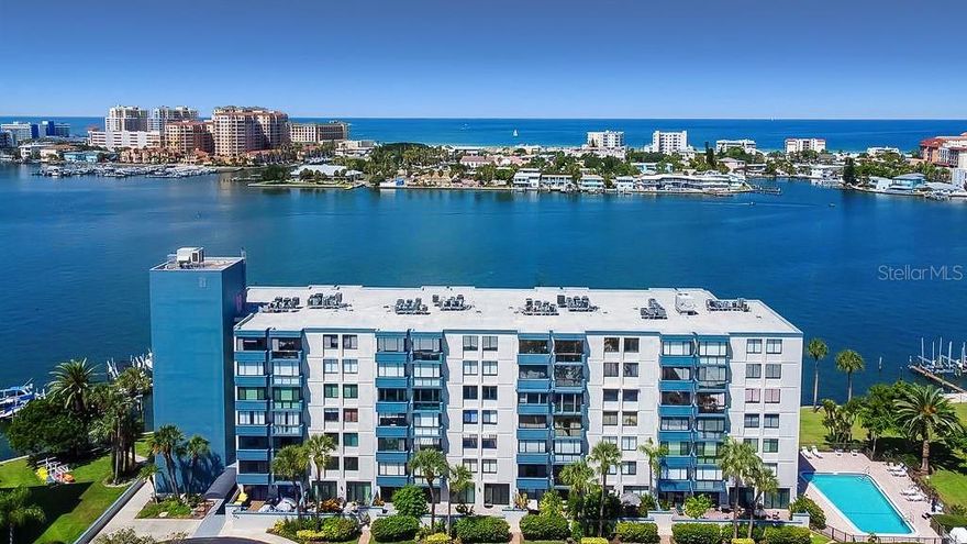 This waterfront condominium is a MUST-SEE!!! Located at 644 Island Way in the highly sought-after Island Estates community, this beautifully updated first-floor residence offers sweeping open-water views and stunning western sunsets. Upon entering, you’re immediately drawn to the light-filled interior and panoramic water views, visible from every room—perfect for watching dolphins, manatees, passing boats, and nightly sunsets. The home has been completely redesigned with an open-concept layout that seamlessly connects the kitchen, dining, and living areas, making it ideal for both everyday living and entertaining. The custom eat-in kitchen features high-end appliances, soft-close cabinetry, quartz countertops with a matching backsplash, and a stylish dry bar with wine refrigerator. A stackable LG front-loading washer and dryer add everyday convenience. The oversized primary bedroom includes a custom ensuite with a walk-in shower and a spacious walk-in closet. The guest bedroom is generously sized, offers beautiful water views, and is complemented by a tastefully updated guest bathroom just across the hall. Luxury vinyl flooring runs throughout the home, with hand-selected polished stone in the primary ensuite. Electric hurricane shutters provide added peace of mind. (AC 2025 / Water Heater 2025.) Community RESORT STYLE amenities include a heated pool, BBQ area, secured lobby, assigned parking (Space #32 directly in front of the building entrance), marina with BOAT SLIPS currently available for lease, kayak storage, and bicycle storage. Ideally located in the heart of Clearwater Beach, this home is just a short walk to Pier 60, award-winning restaurants, boutique shopping, and the world-famous sugar-sand beaches. Convenient access to hospitals, medical centers, and both Tampa and St. Pete–Clearwater airports completes the package. Call today and begin living the Florida lifestyle tomorrow!