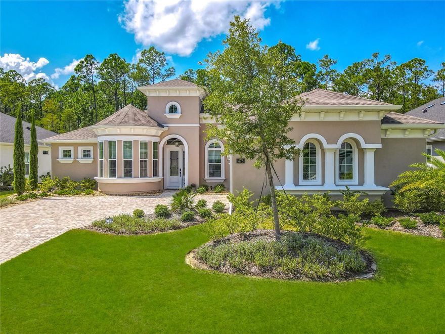 Gated access, lakes, preserves and unlimited amenities that you choose to use, including the new world class Golf Country Club facility. The Stirling Bridge Sub Community boasts the newest luxury homes meeting the demands of today's buyer trends, and this home will not disappoint you! This 2024 Custom Built Pool home offers unlimited upgraded features down to the finest detail! Positioned on a private wood preserve, extensive transom windows added to this design pour natural light and nature into the living spaces. Built-in features make this home a one of a kind! The kitchen has a nine foot, 3-inch-thick waterfall quarts island, custom wood hood vent and extended display lit cabinetry accentuating the soaring ceilings of the home. The open floor plan has double tray crown molding ceilings in living area with stone wall/shelving and triple sliding pocket doors out to the pool. The split plan primary suit has double walk-in closets with barn door sliders, sitting area, and stunning walk-in shower for a home spa feel. This four-bedroom home has a large fenced-in yard for the two- and four-legged family members, and over 1400 SF Lania enclosing the travertine patio, pool, spa, as well as the 19 X 11 ft covered patio area. Love where you live! Just a short drive to the beaches of Flagler and Volusia County!